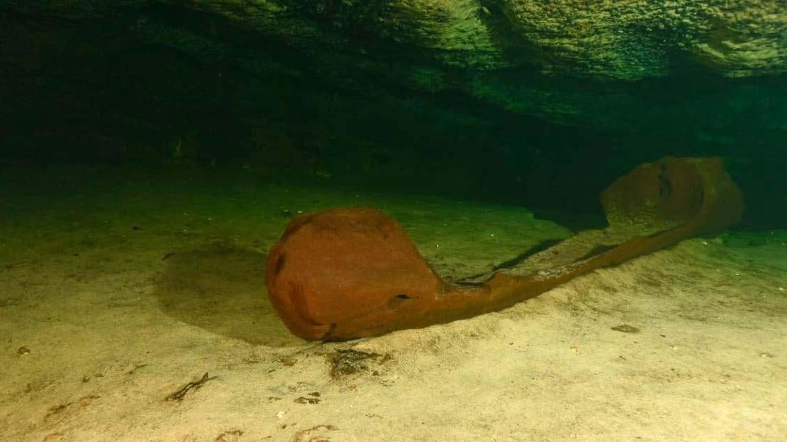 The over-1000-year-old canoe, submerged in the cenote.