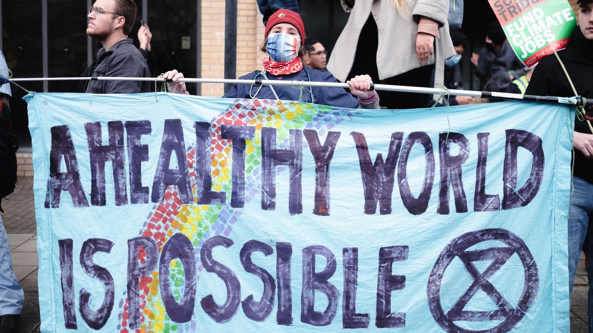 Doctor Helena Clements holds a sign with Doctors for XR.