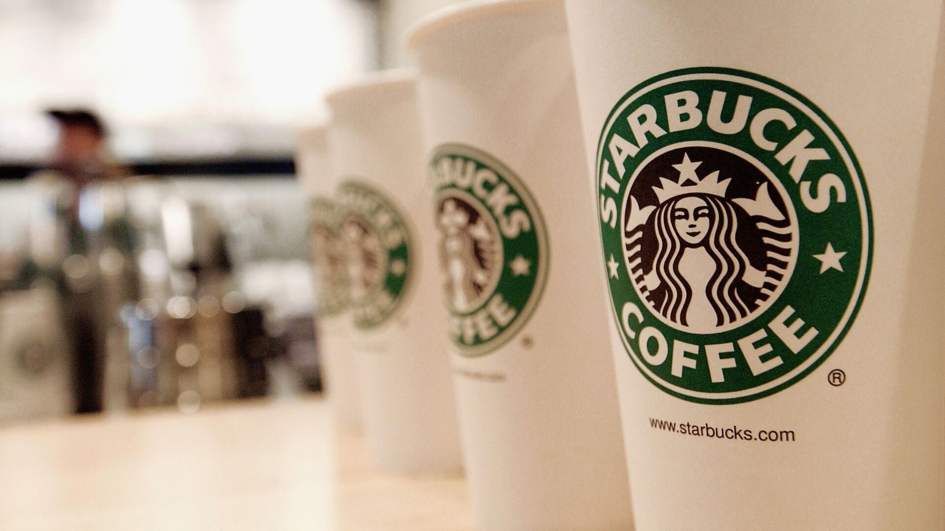 Beverage cups featuring the logo of Starbucks Coffee.