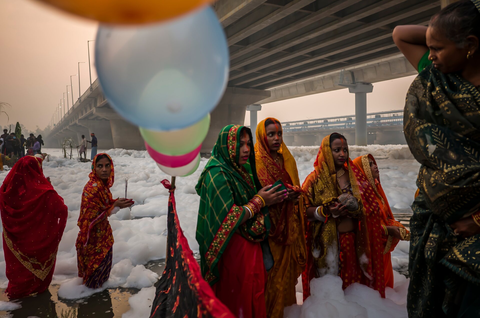 People take a dip in the waters of River Yamuna.
