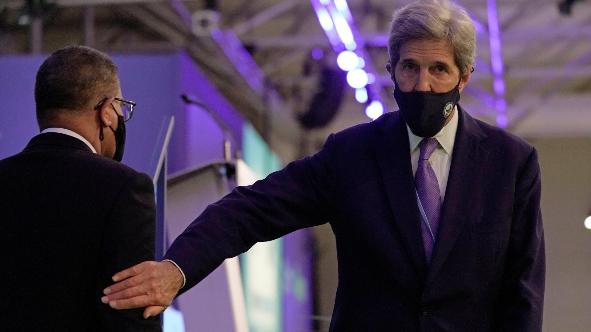 John Kerry, United States Special Presidential Envoy for Climate, right, touches the arm of Alok Sharma President of the COP26 summit during a stocktaking plenary session at the COP26 U.N. Climate Summit in Glasgow, Scotland on Saturday.