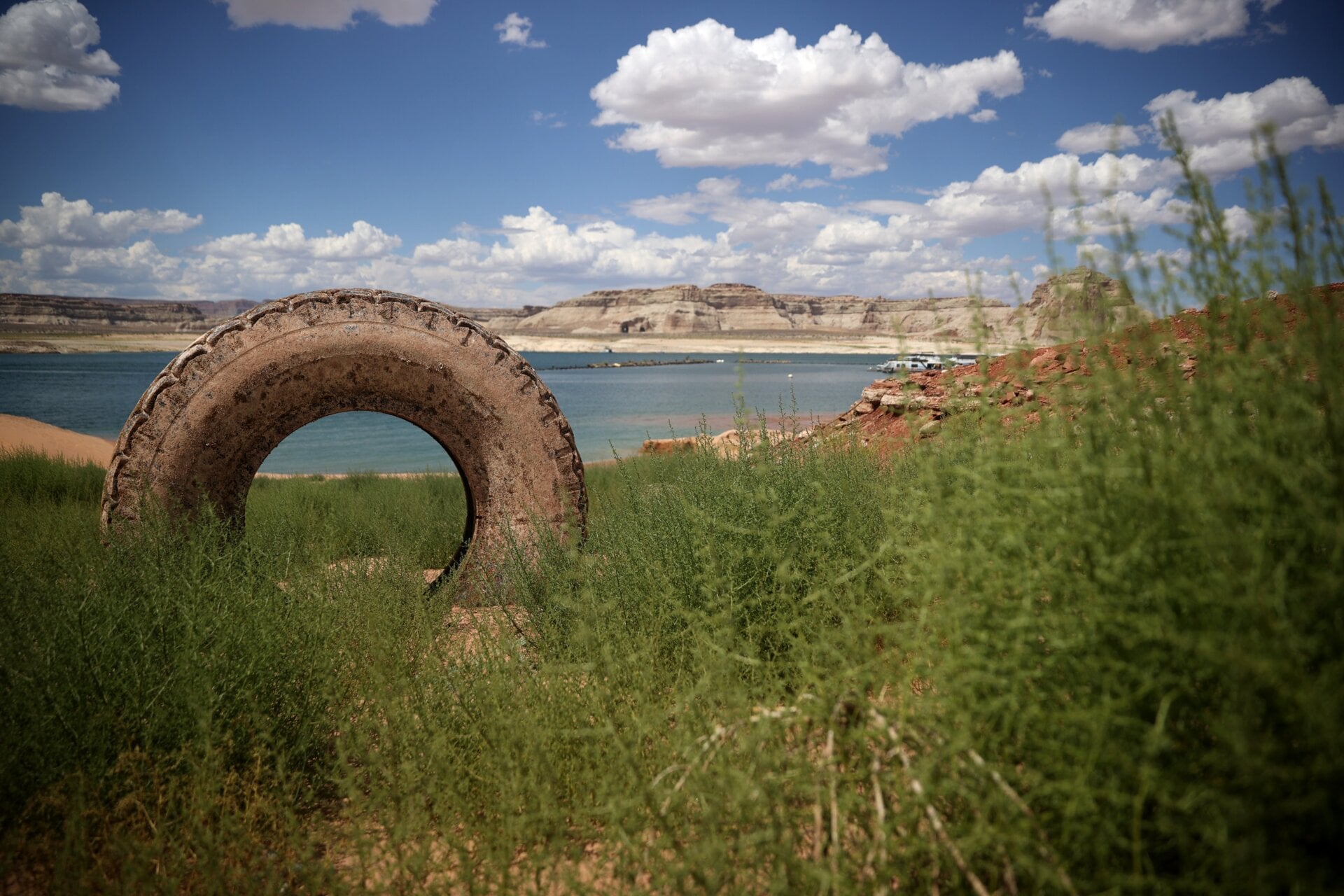 A tire sits on dry land in a section of Lake Powell that used to be underwater on June 24, 2021 in Lake Powell, Utah.