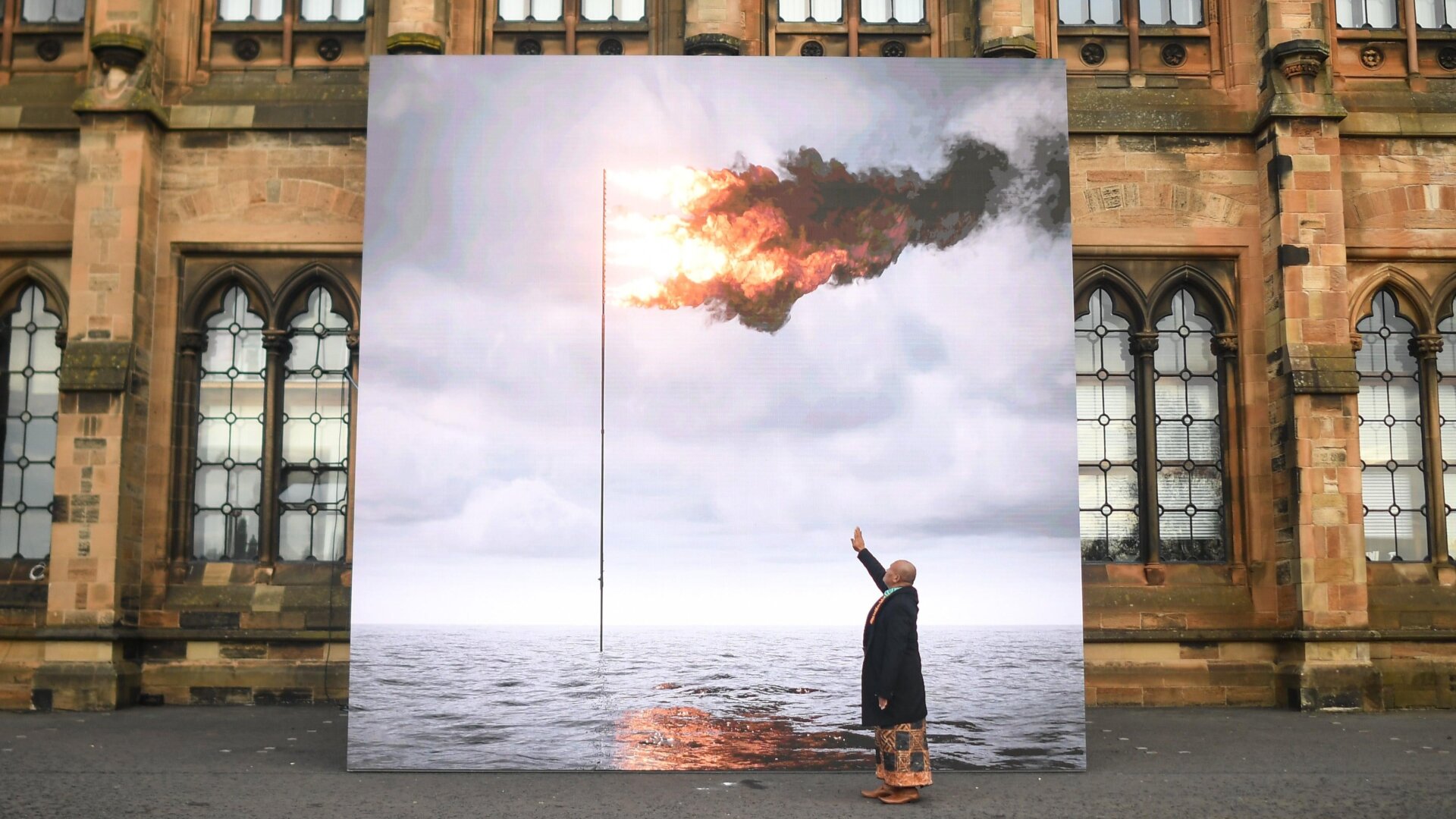 Tongan artist and climate activist, Uili Lousi, is seen with John Gerrards Flare Oceania 2021.
