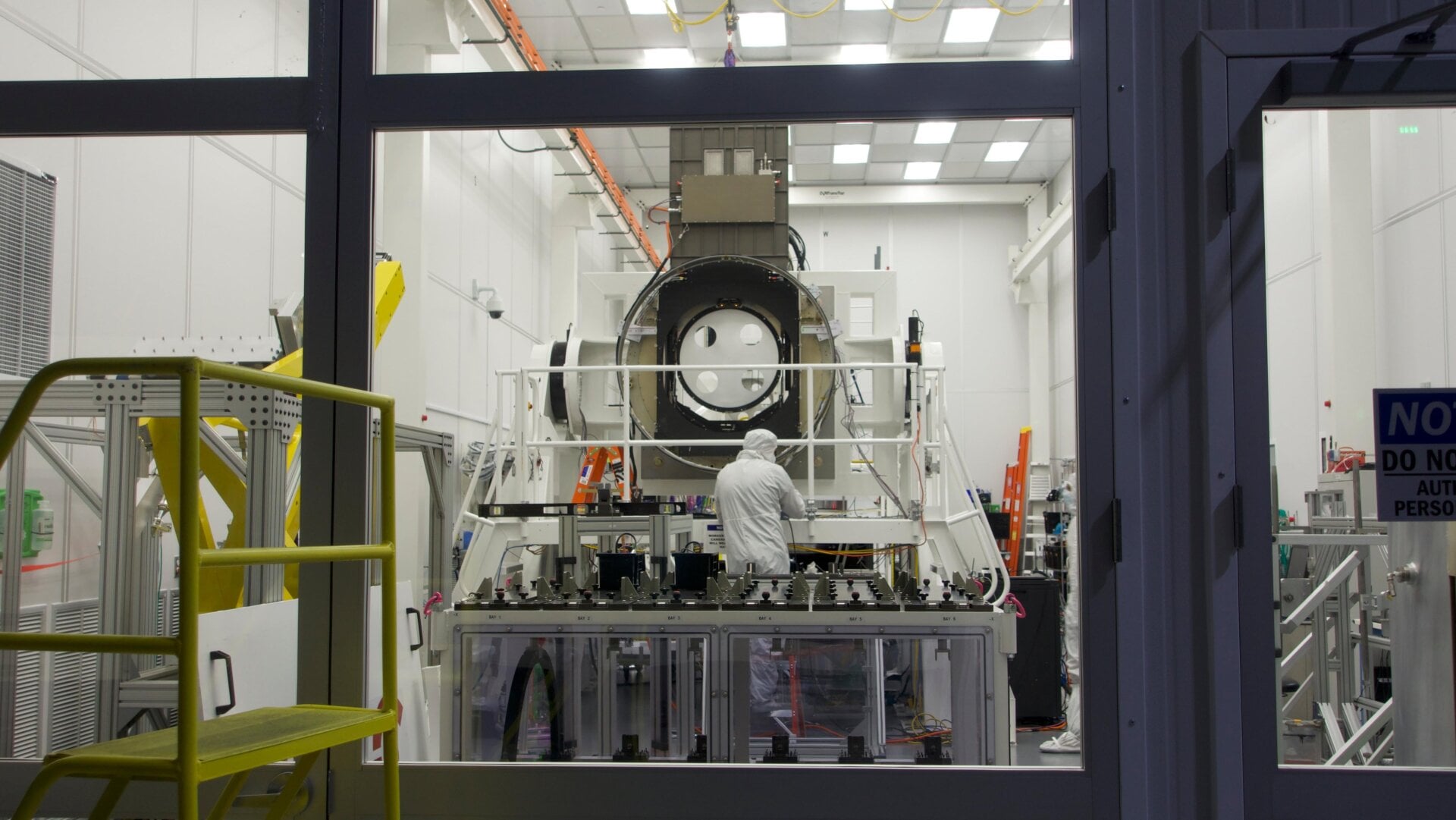 Components of the camera being worked on in a clean room at SLAC National Accelerator Laboratory.