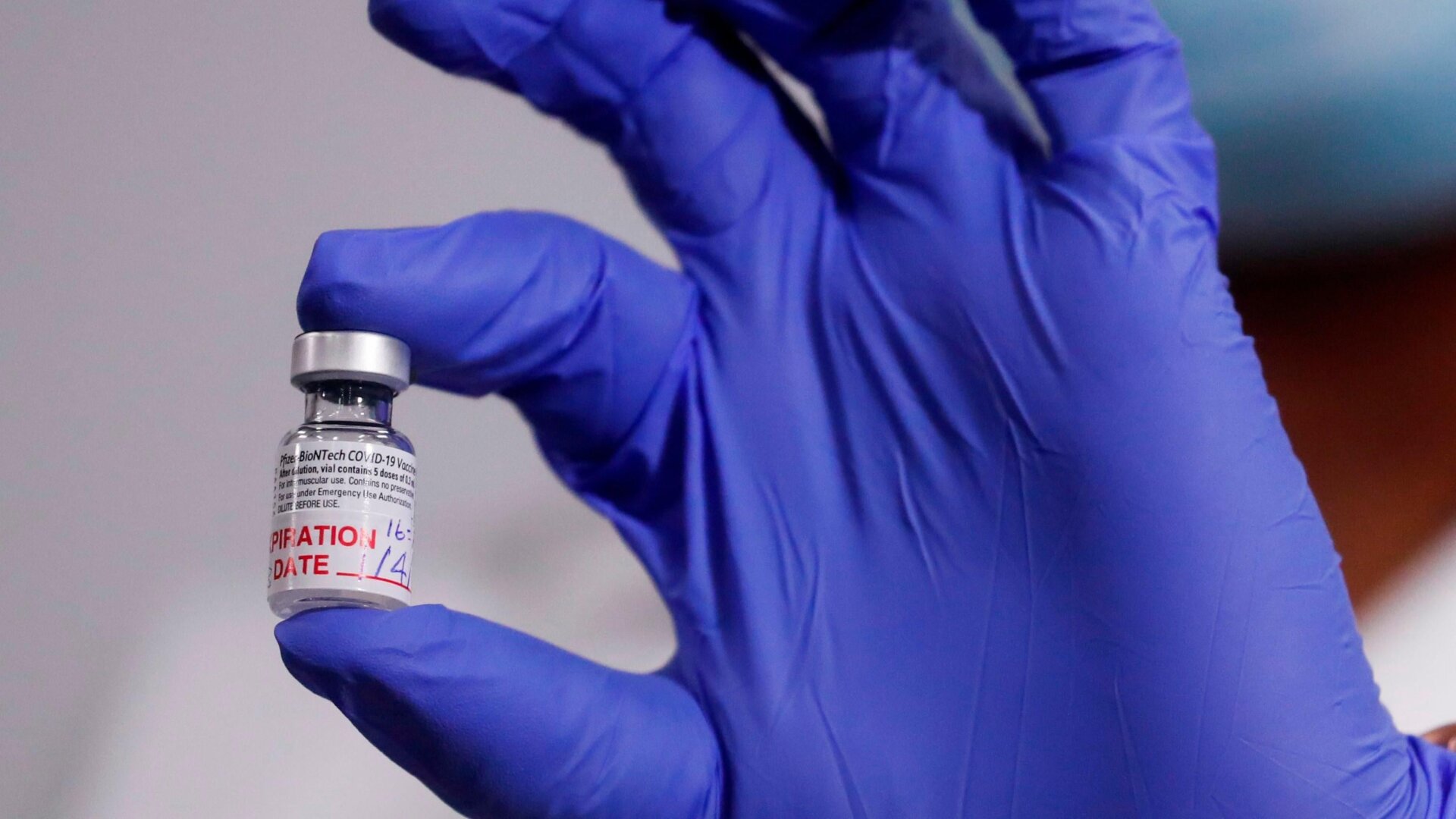 A medical worker displaying a vial of the Pfizer/BioNTech covid-19 vaccine.