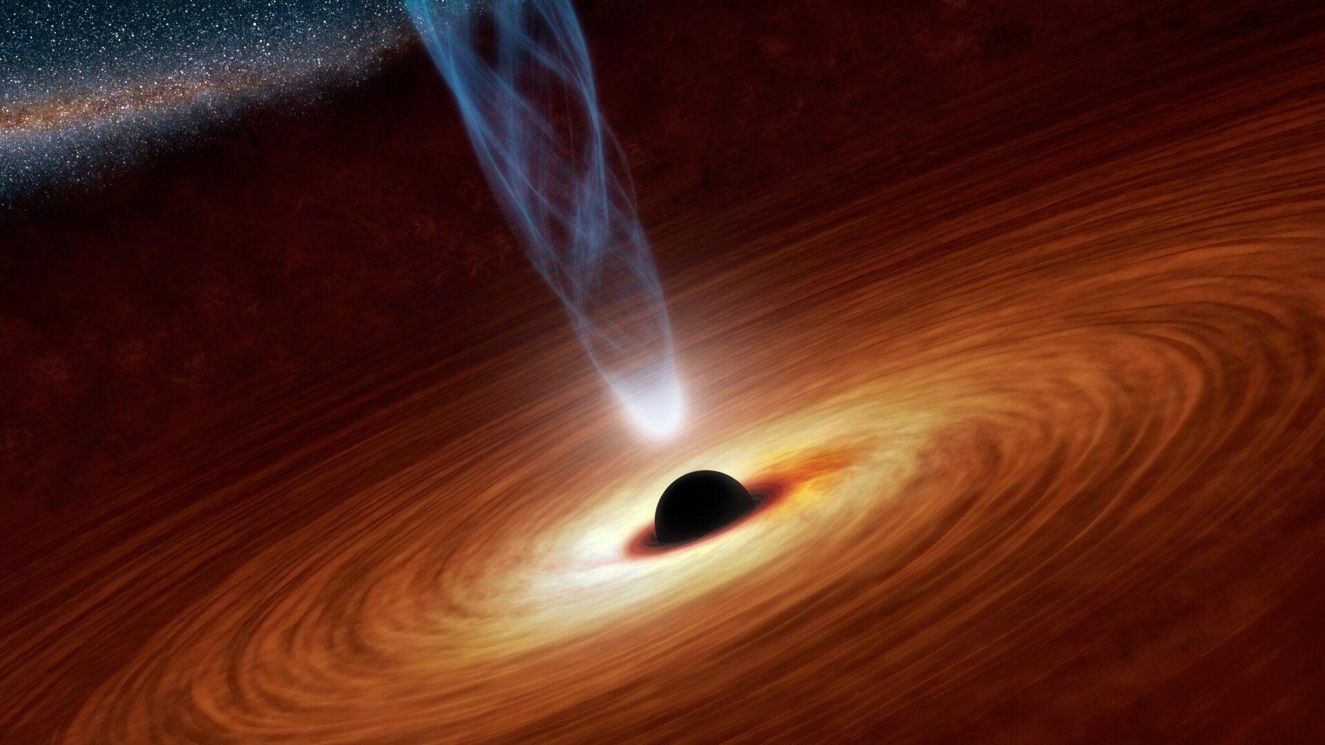 An artist’s concept of a supermassive black hole in its accretion disk, spewing out a jet of particles.