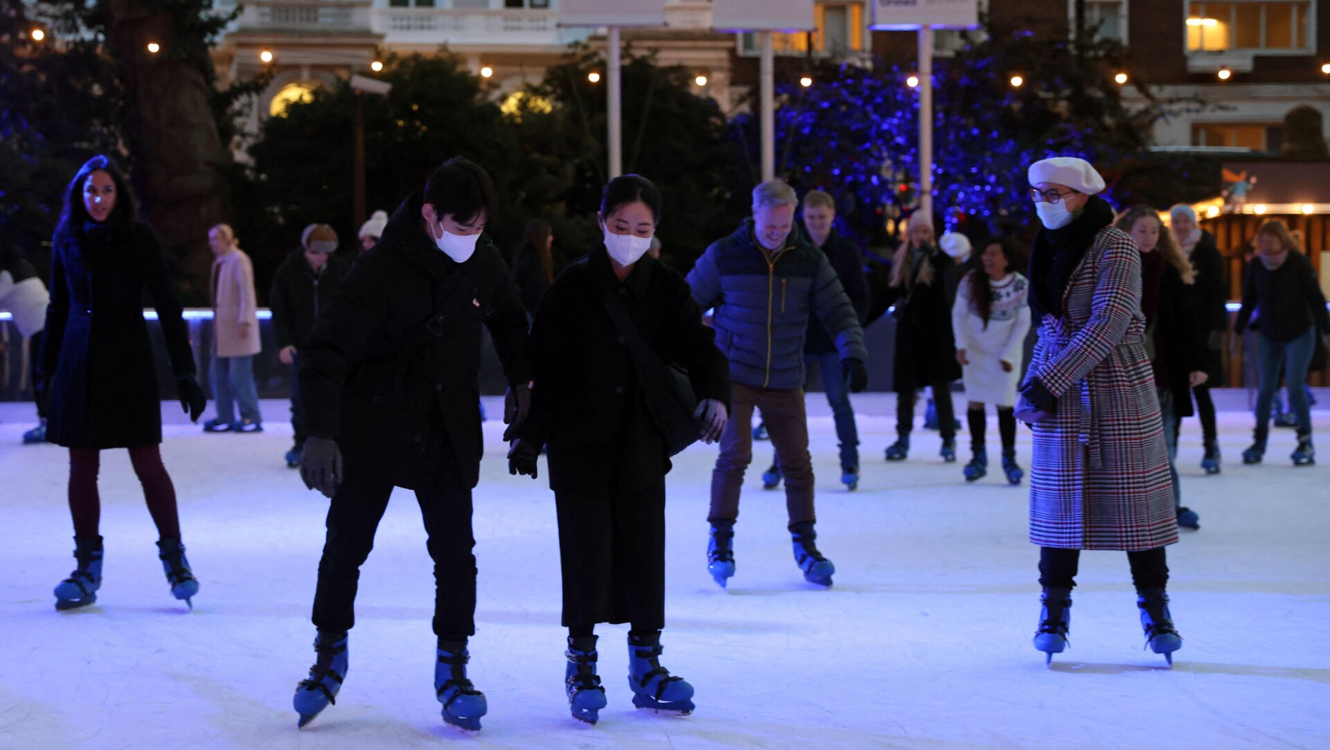 Skaters on the ice rink at the Natural History Museum in central London on December 9, 2021.