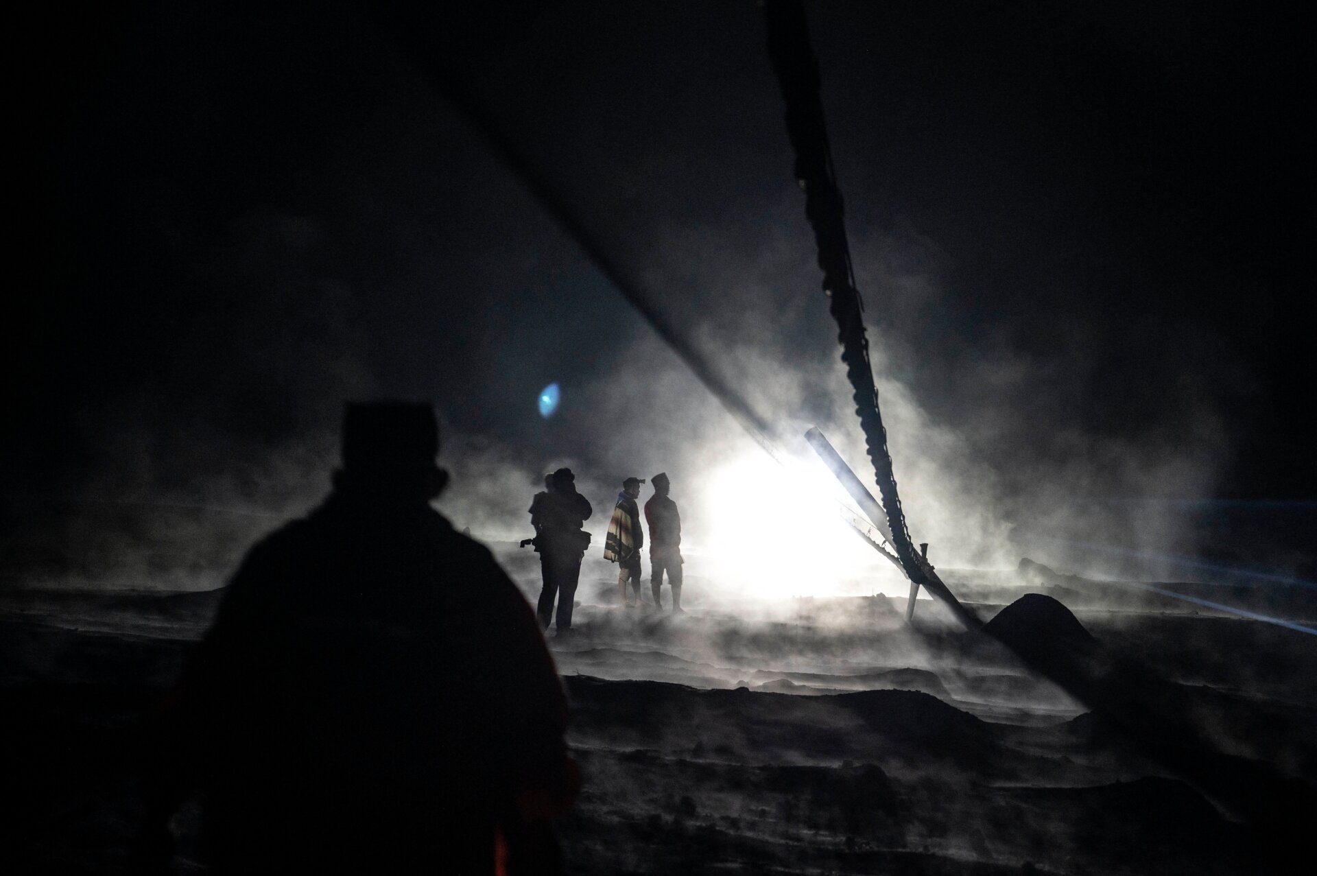 Villagers and rescuers inspect an area covered with volcanic ashes at Sumber Wuluh village, in Lumajang.