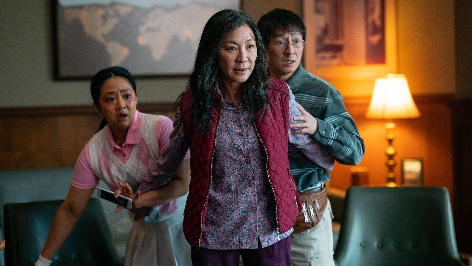Stephanie Hsu and Ke Huy Quan stand with Michelle Yeoh in Everything Everywhere All at Once.