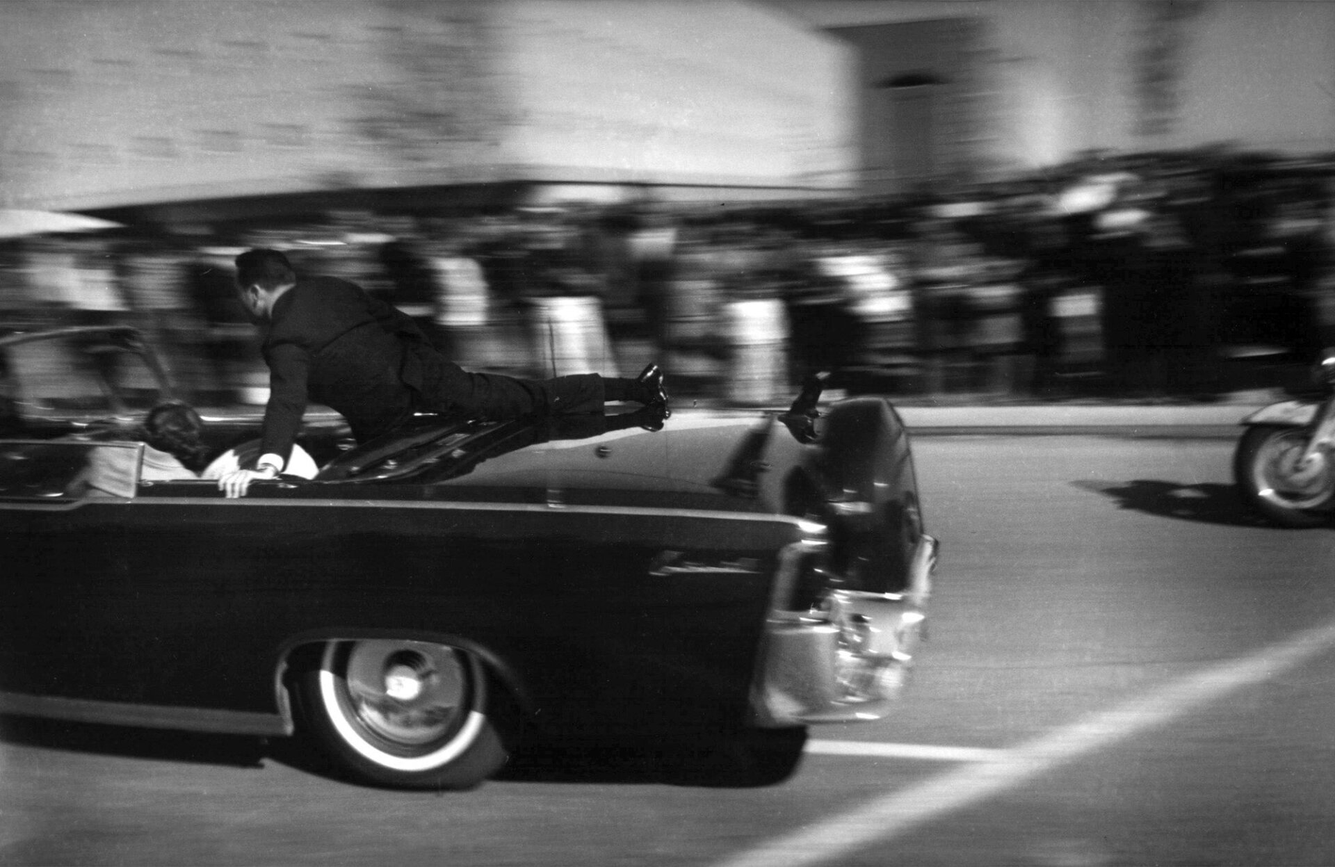 The limousine carrying President John F. Kennedy races toward the hospital seconds after he was shot in Dallas on Nov. 22, 1963.