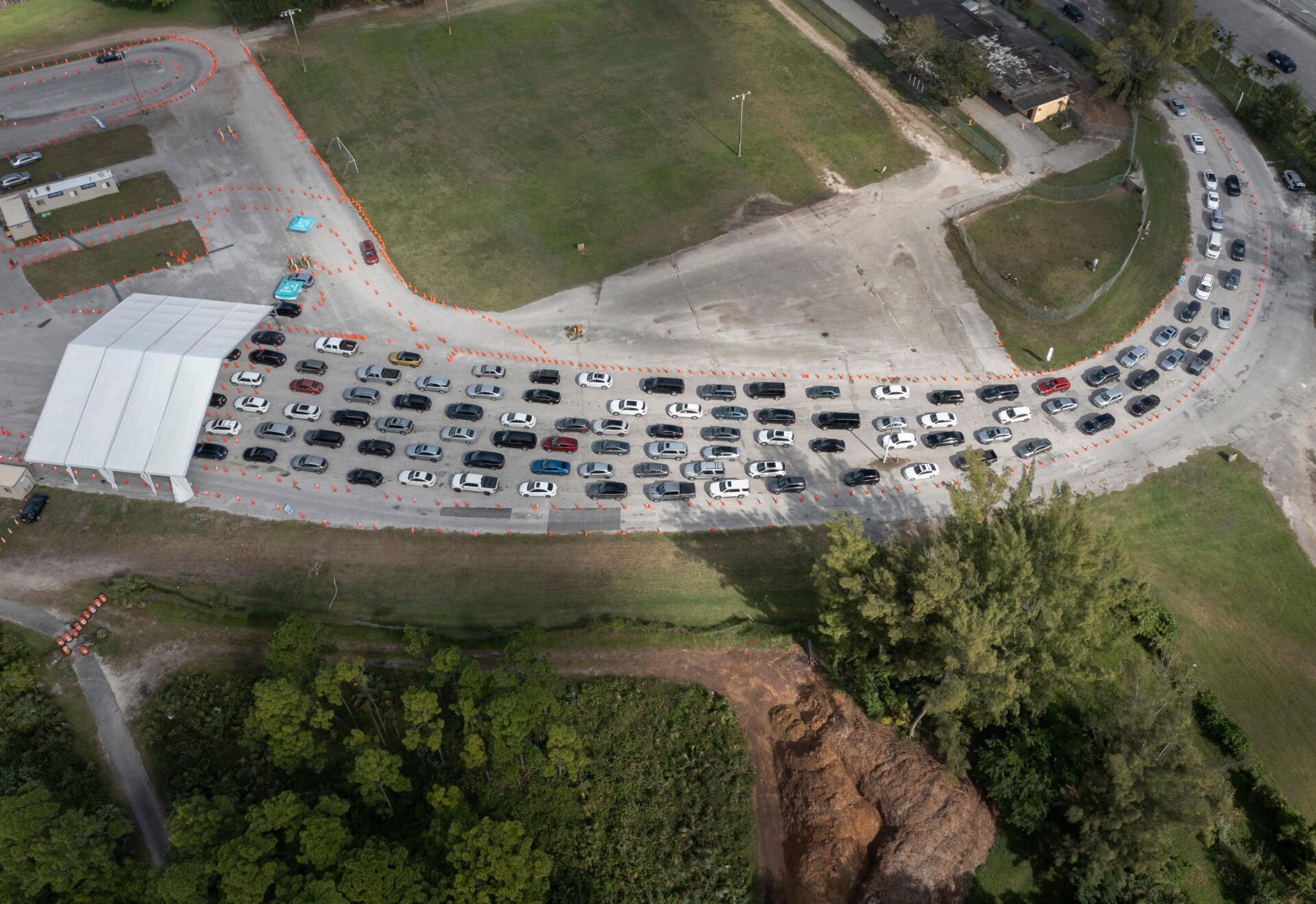 Cars line up at a drive-thru covid-19 testing site in Miami, Florida on December 17, 2021.