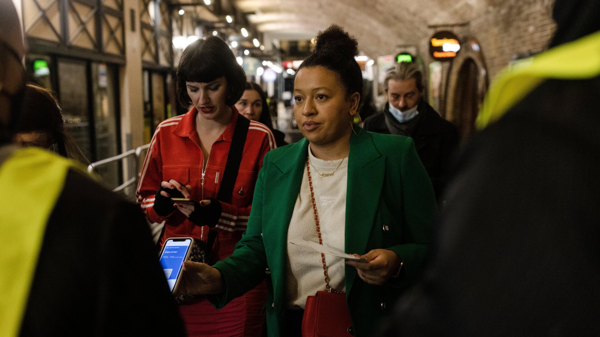 Members of the public display their covid-19 vaccination passes as they arrive at Heaven nightclub ahead of a performance by the House Gospel Choir on December 15, 2021 in London, United Kingdom.
