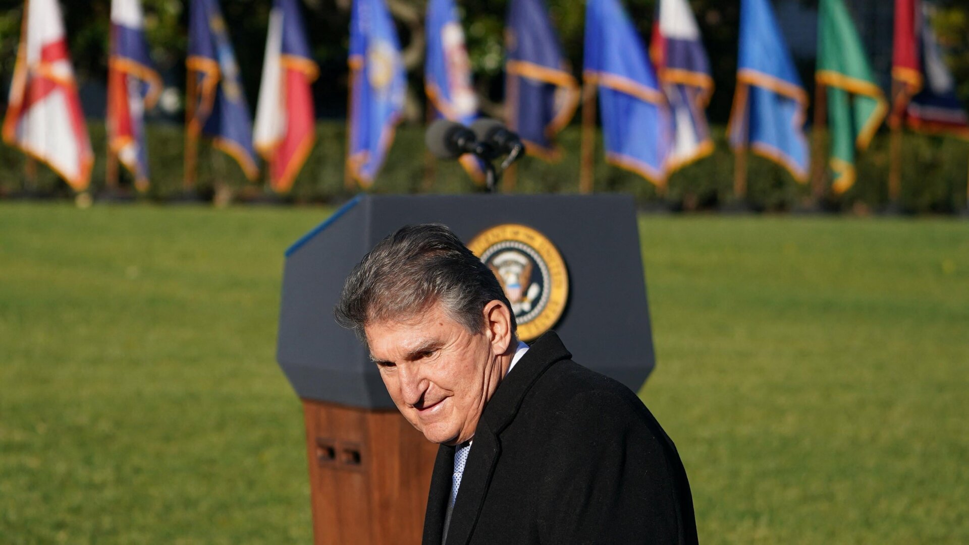 Sen. Joe Manchin arrives before President Joe Biden takes part in a signing ceremony for the bipartisan infrastructure bill.