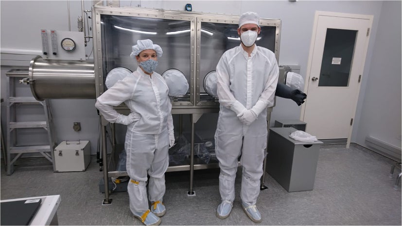 ESA scientists Francesca McDonald and Timon Schild standing next to their “Apollo can opener.”