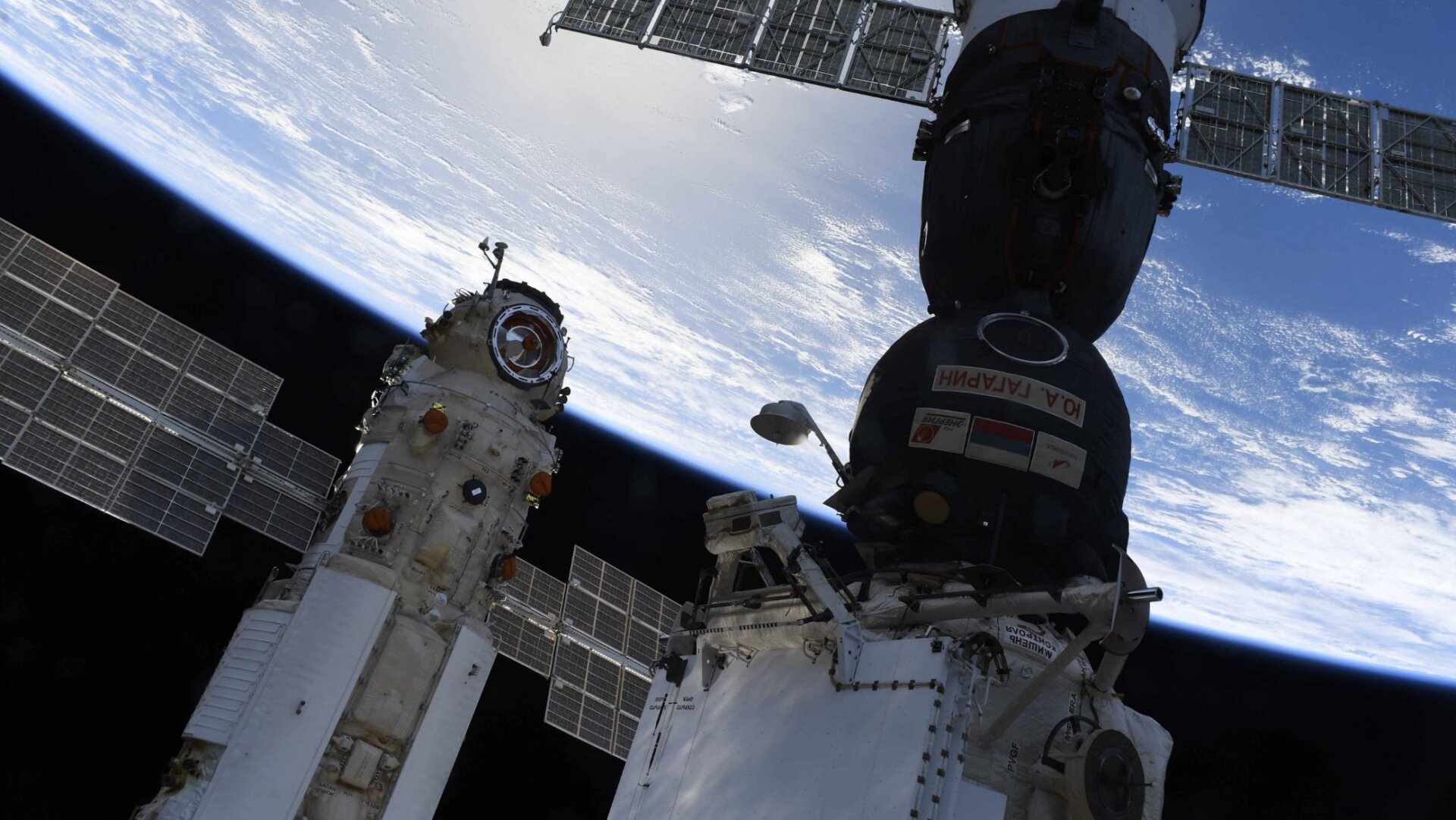 The Nauka module (left) docked to the ISS, with a Soyuz spacecraft (right) parked nearby. 