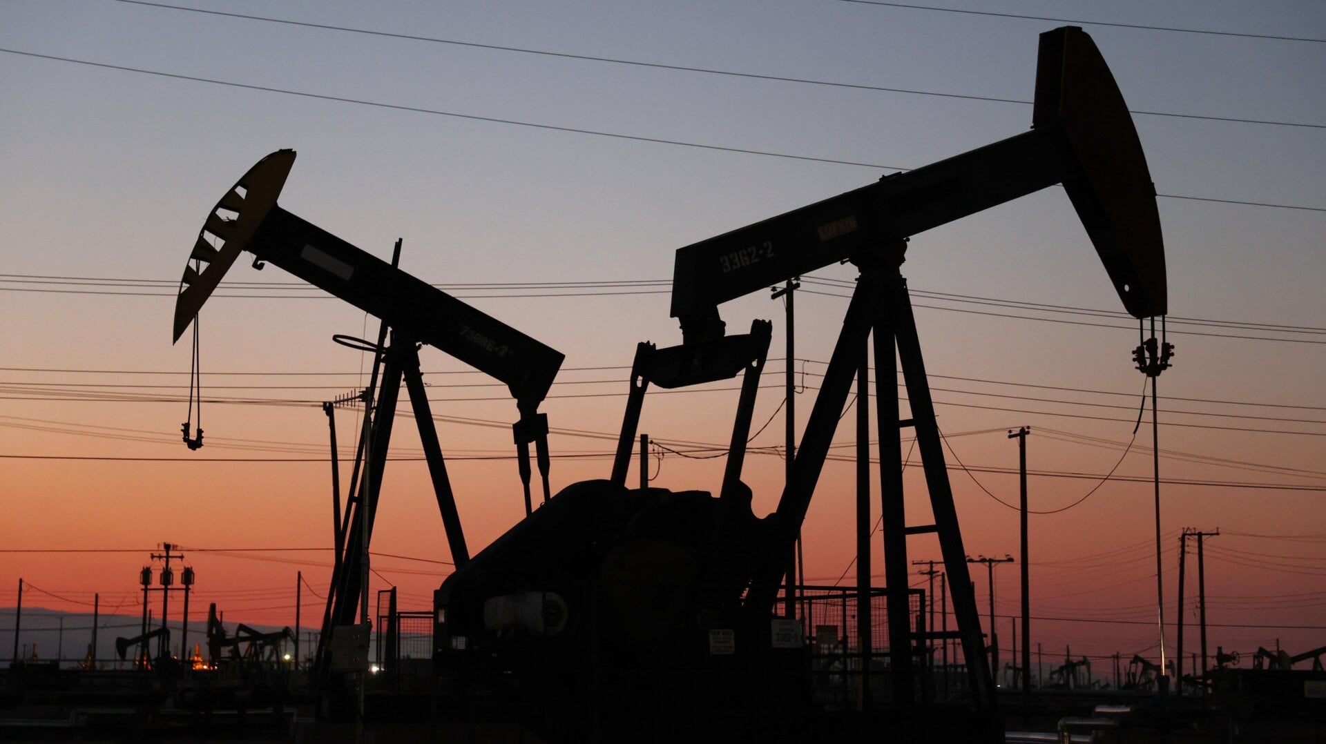 The sun sets beyond pumpjacks in the Belridge oil field near McKittrick, California.