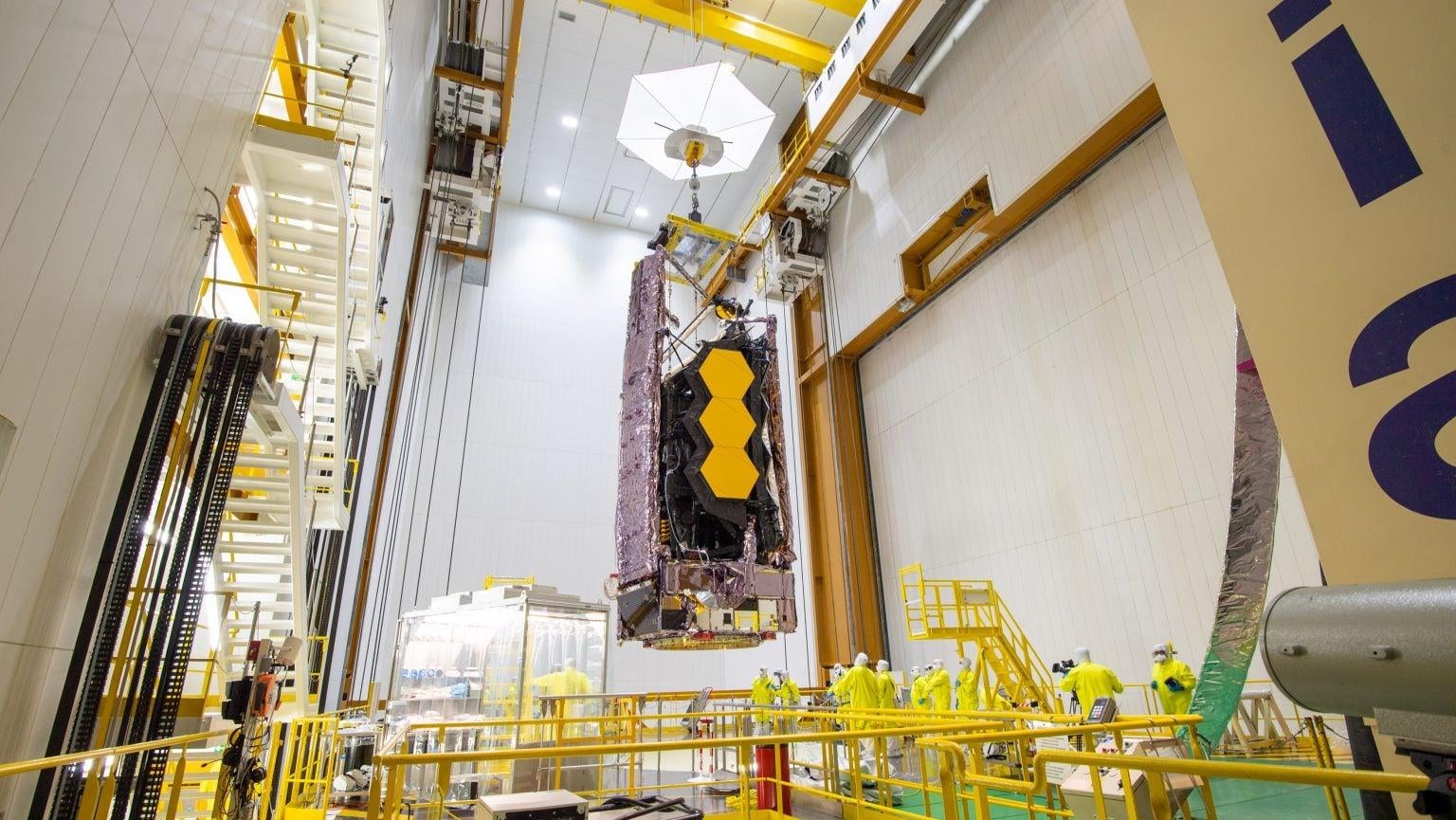 The Webb space telescope being hoisted to the top of an Ariane 5 rocket.