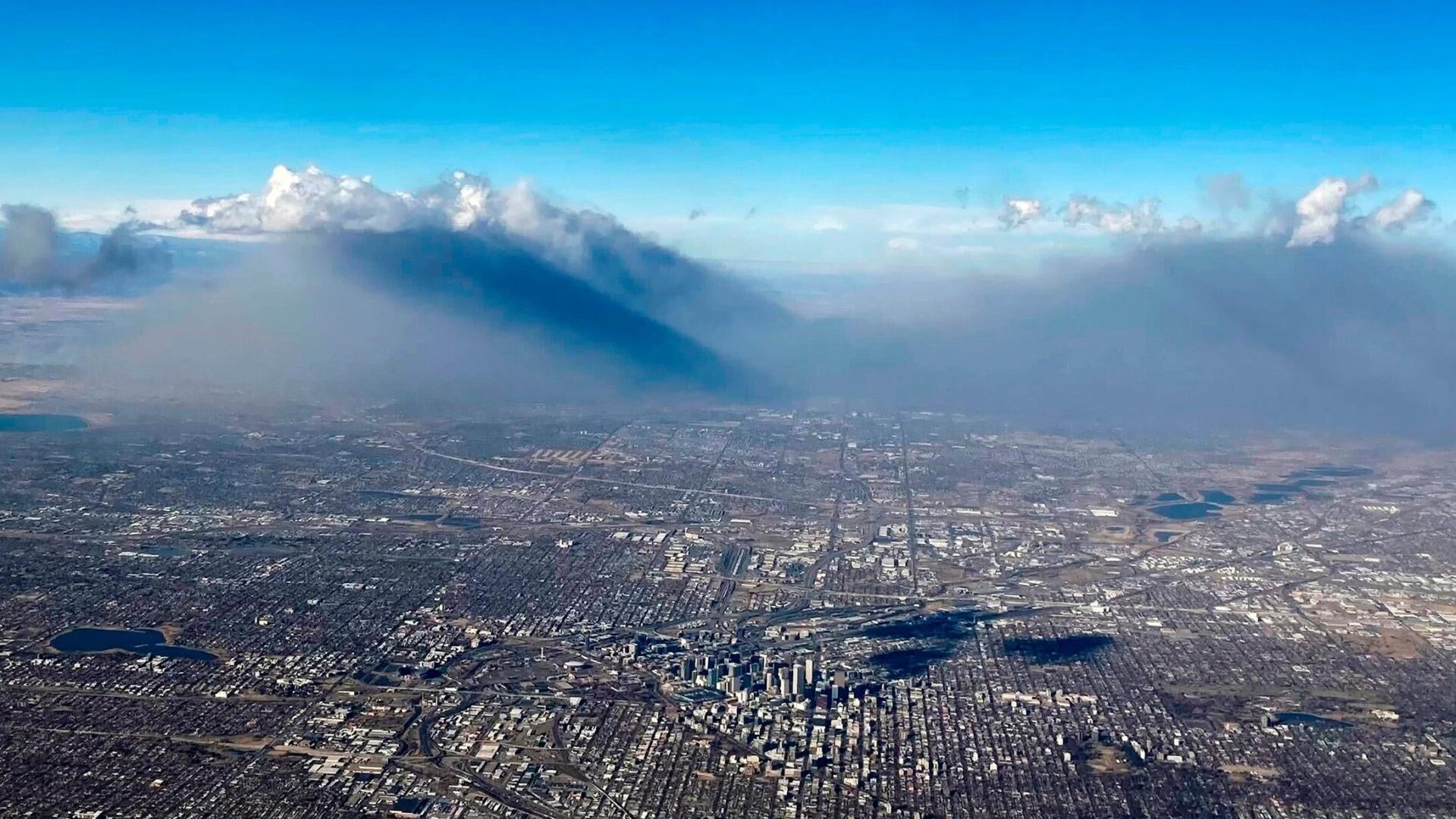Smoke from wildfires rises into the air north of Denver on Thursday, Dec. 30, 2021.