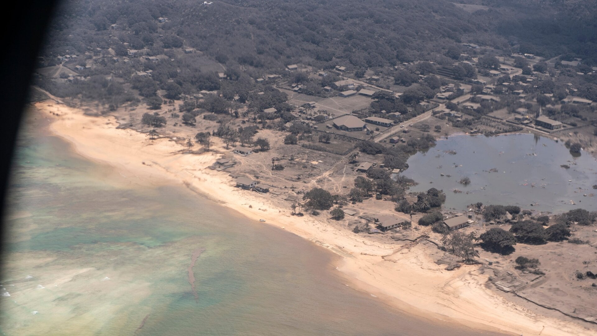 Volcanic ash covers rooftops and vegetation in a photo taken Jan. 17, 2022, following a volcanic eruption in Tonga.