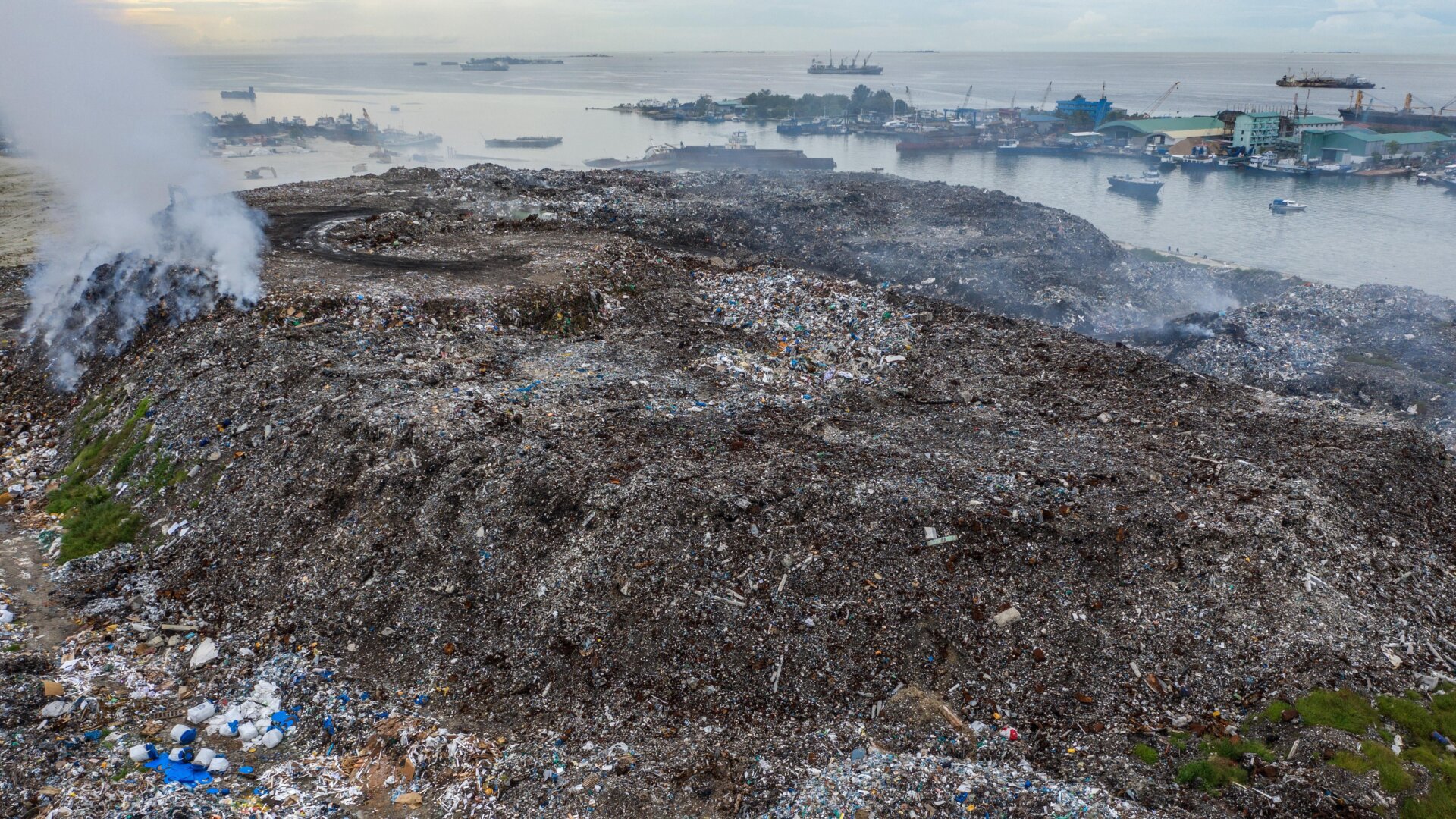 Smoke rises from burning rubbish at a landfill site on the artificial island of Thilafushi.