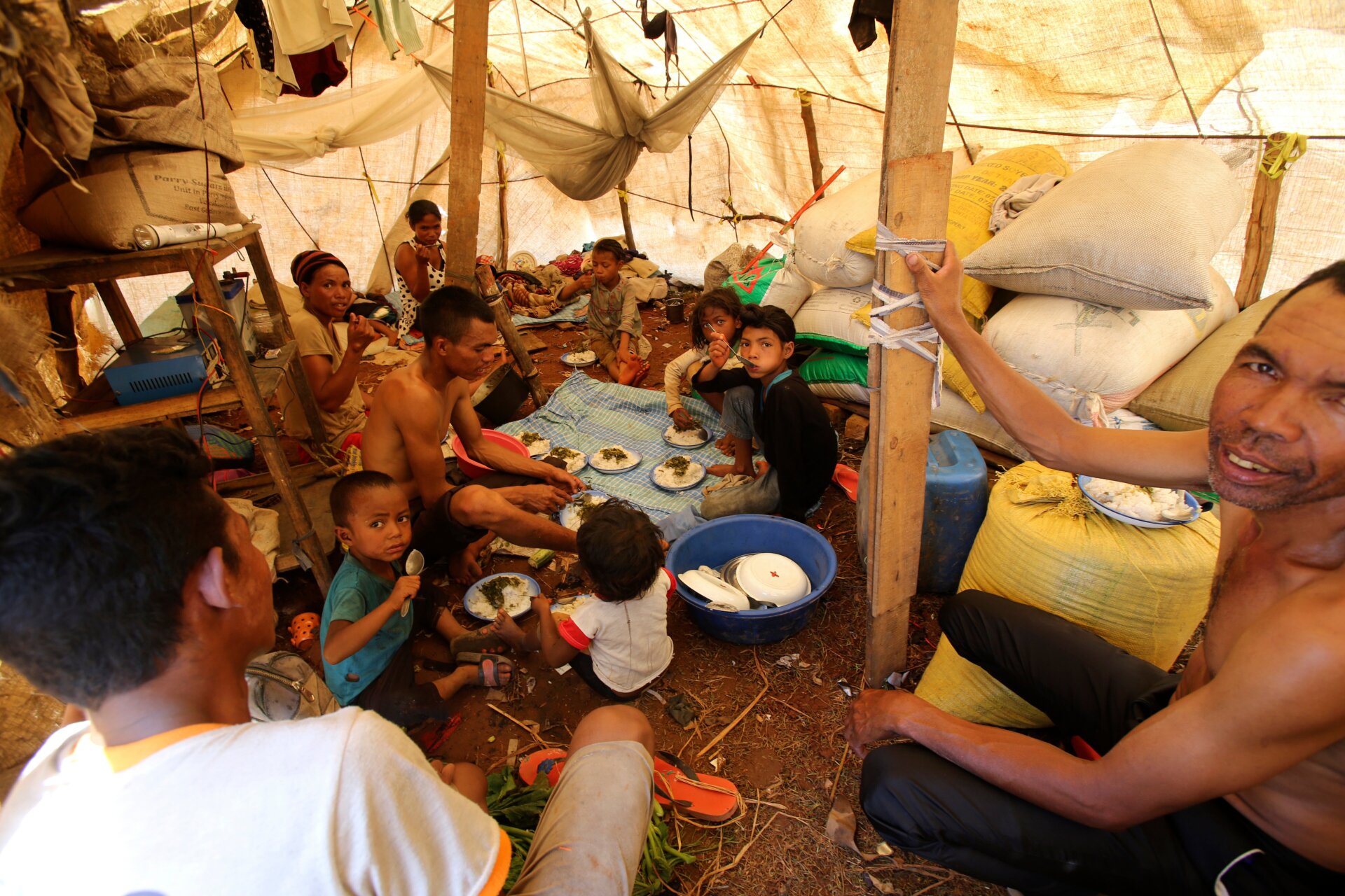 People whose homes have been destroyed by tropical storm Ana find shelter under plastic sheeting in Antananarivo, Madagascar, Wednesday, Jan. 26.
