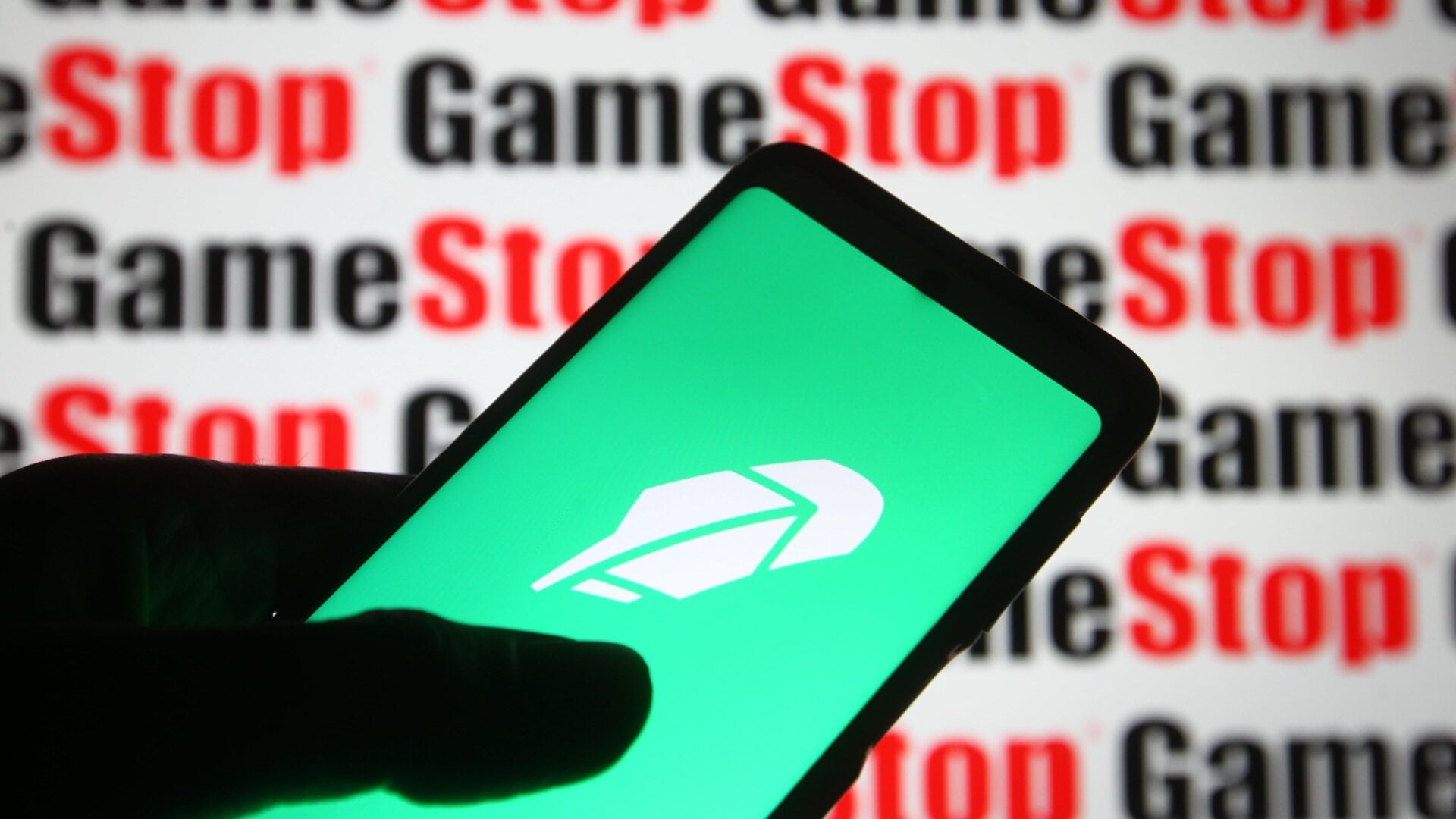 The Robinhood logo displayed in front of the logo of meme stock Gamestop, February 2021.