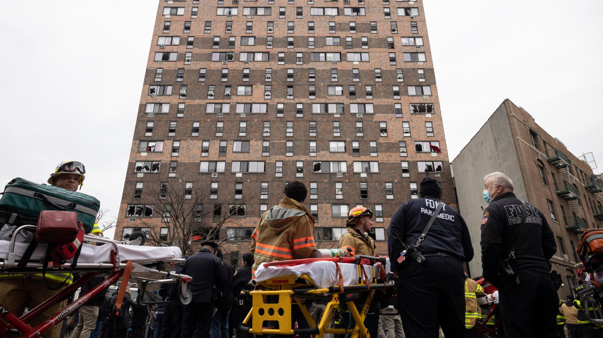 Emergency personnel work at the scene of a fatal fire at an apartment building in the Bronx on Sunday, Jan. 9, 2022, in New York.