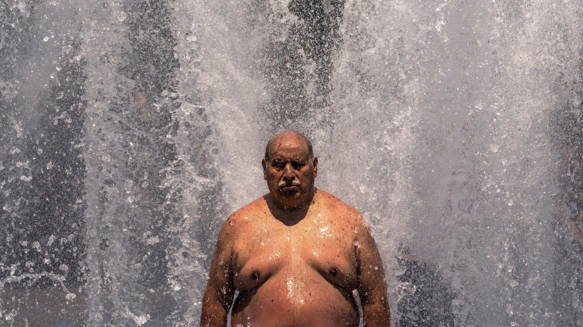 Pablo Miranda cools off in the Salmon Springs Fountain on June 27, 2021, in Portland, Oregon. Record-breaking temperatures lingered over the Northwest during a historic heatwave this weekend.  