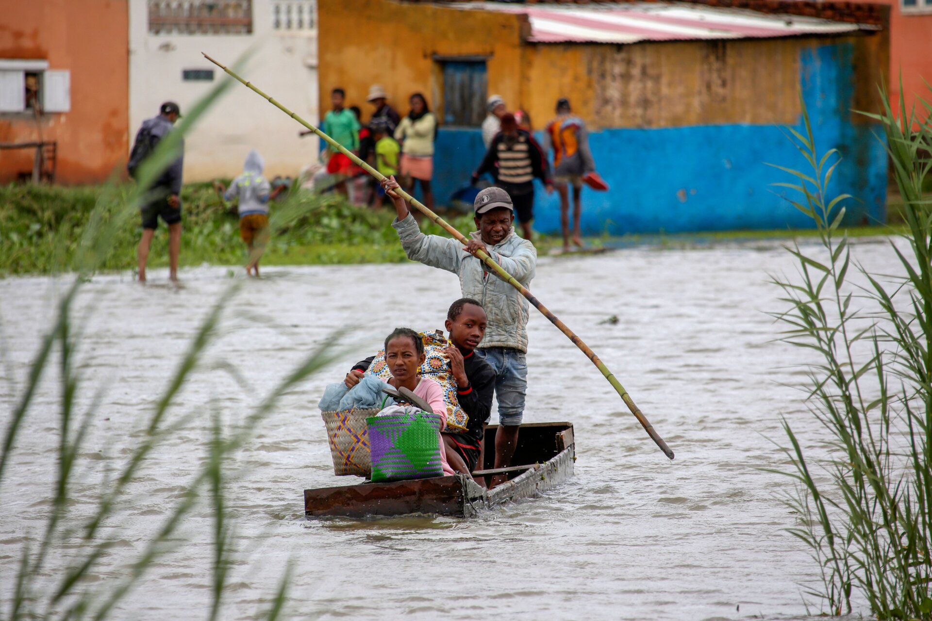A family take their belongings after their home was flooded after a week long of heavy rain, in Antananarivo, Madagascar, Monday, Jan. 24.