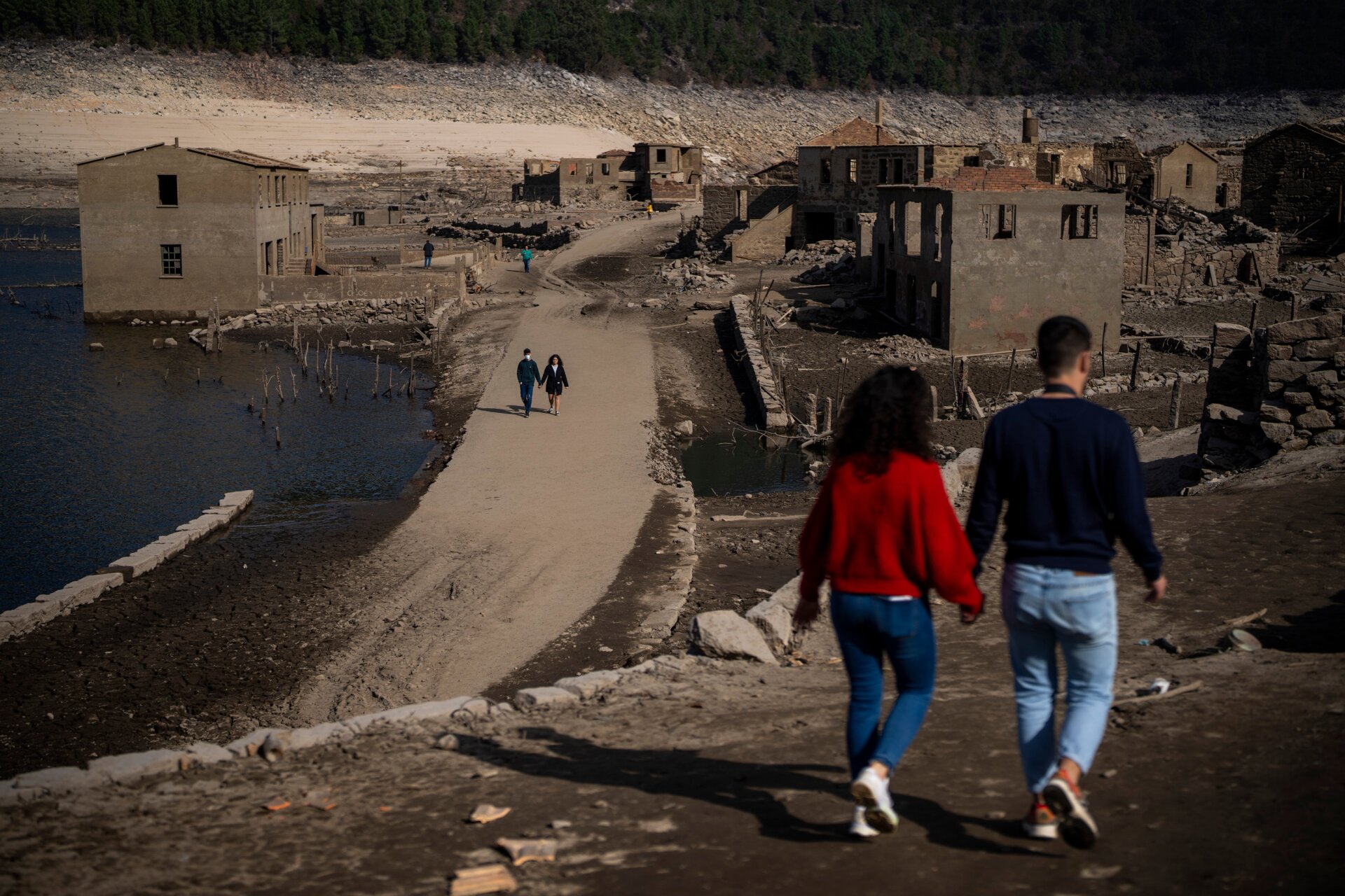 Visitors walk at the old village of Aceredo.