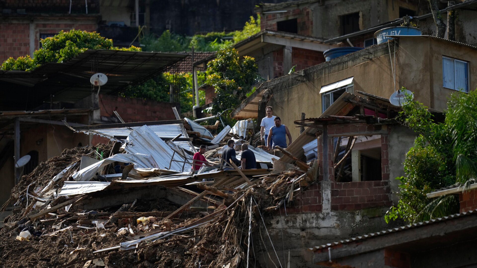 Residents and volunteers look for victims after mudslides in Petrópolis, Brazil.