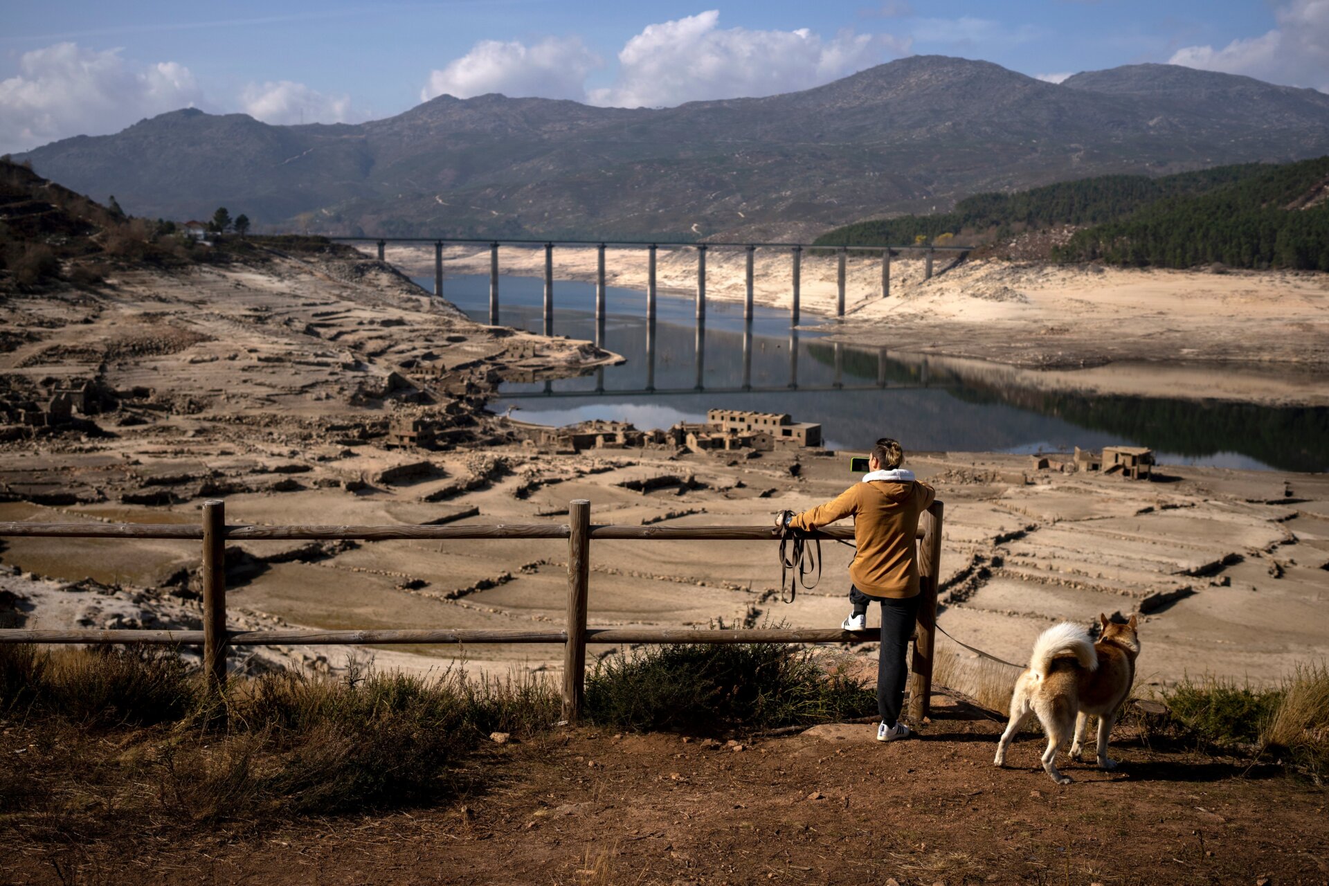 A man photographs the old village of Aceredo.