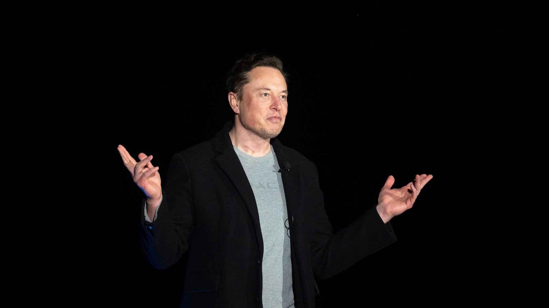 Elon Musk gestures as he speaks during a press conference at SpaceX’s  Starbase facility near Boca Chica Village in South Texas on February 10,  2022.