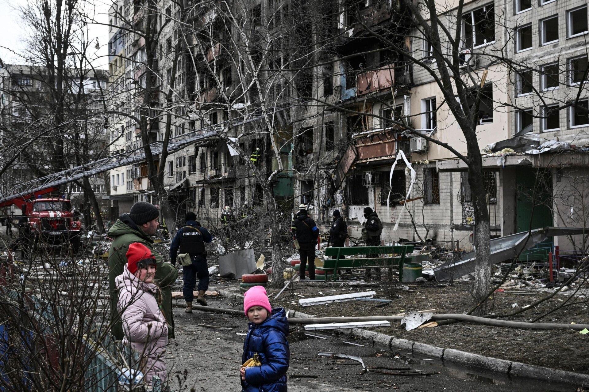 Children stand in front of a destroyed apartment building  following Russian shelling in the northwestern Obolon district of Kyiv, Ukraine on March  14, 2022.