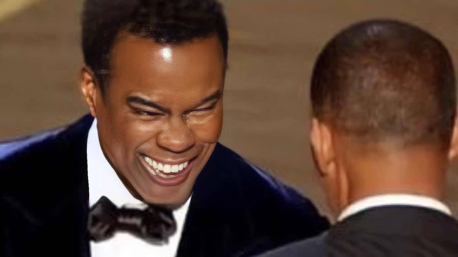 Image of Chris Rock “upscaled” with AI on the iPhone app Remini.