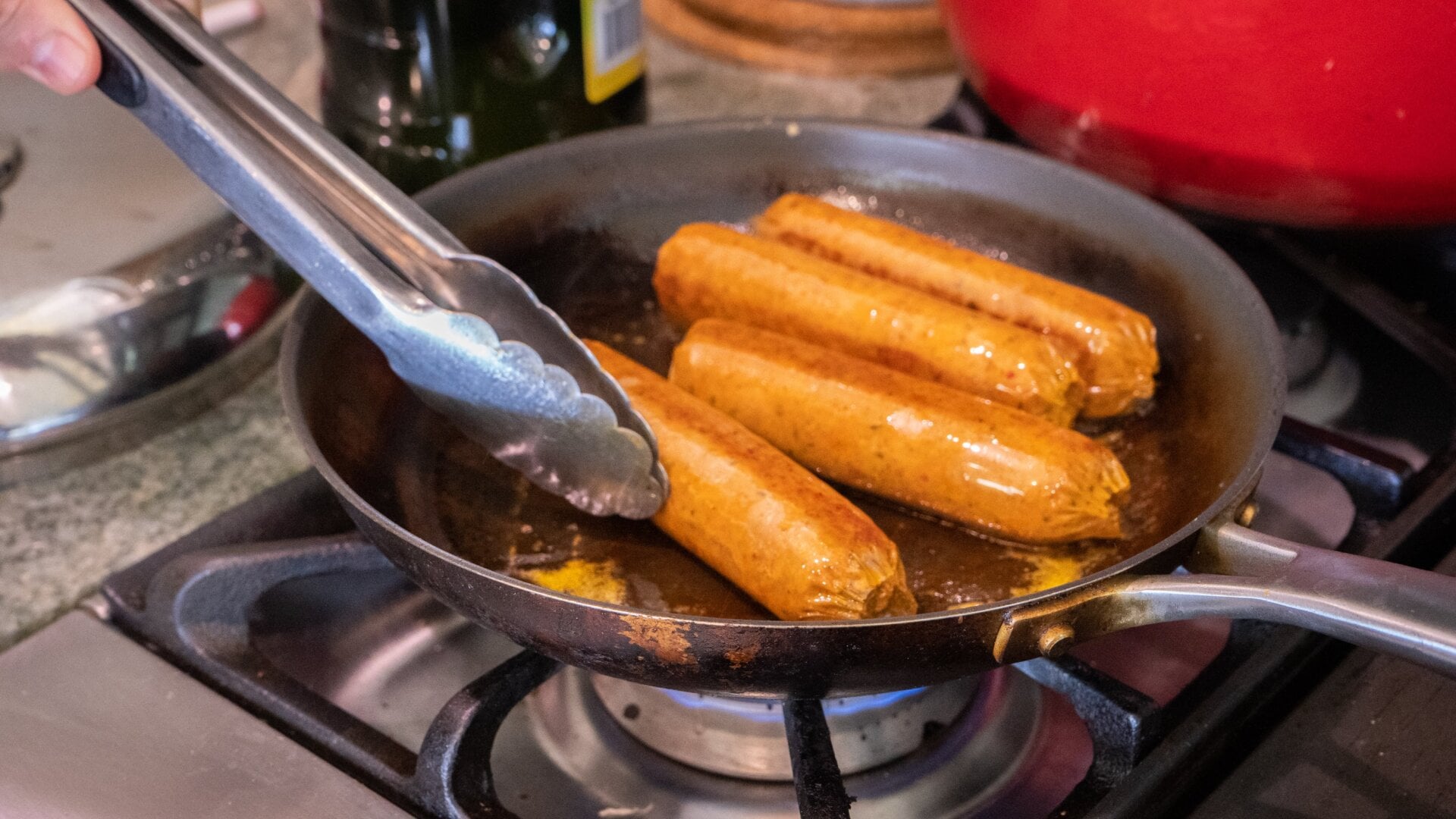 The Impossible Foods sausages don’t quite expand like regular ones, but they do “sweat” into the cooking oil. 