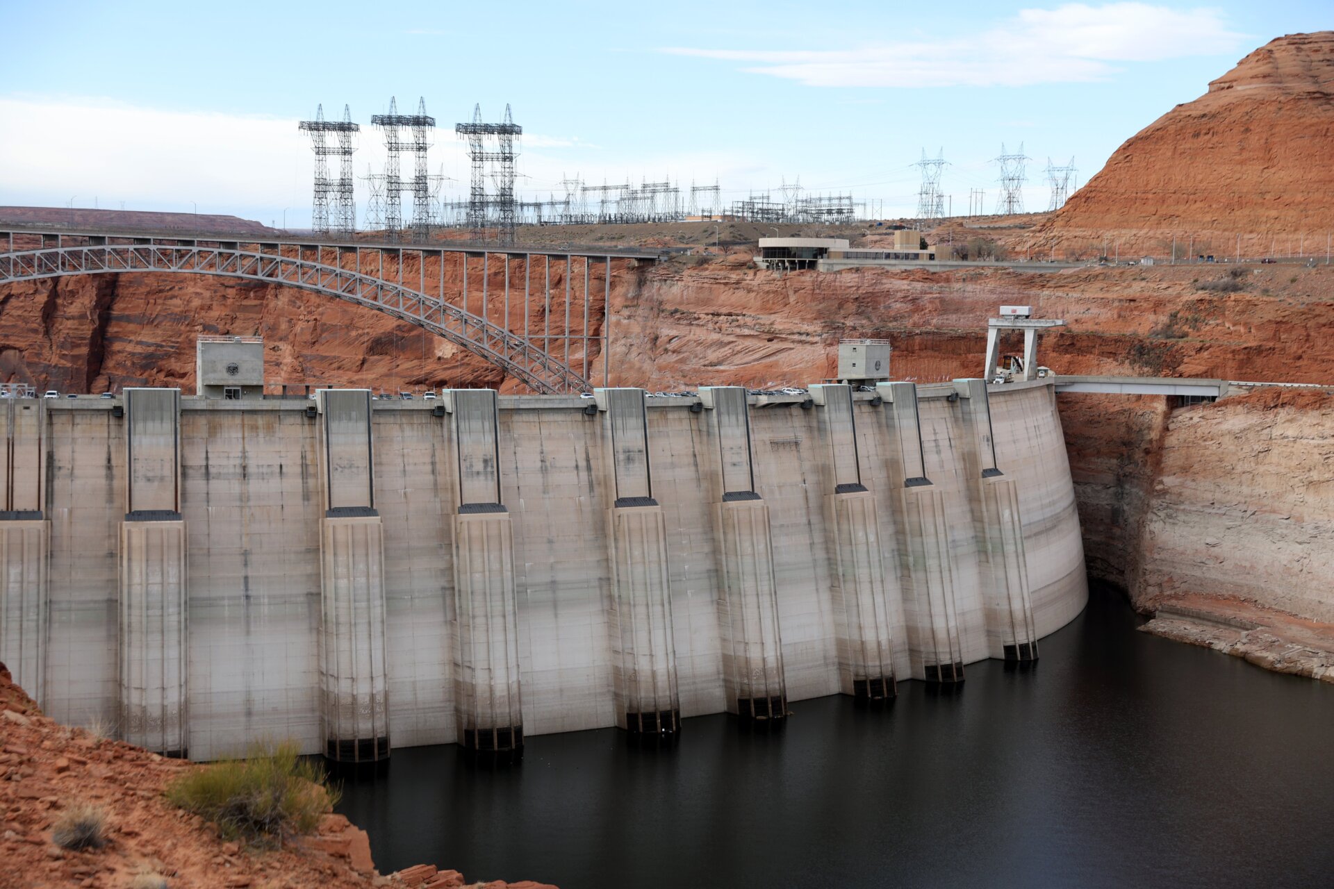 Electrical transmission towers stand near the Glen Canyon Dam at Lake Powell on March 28, 2022 in Page, Arizona. 
