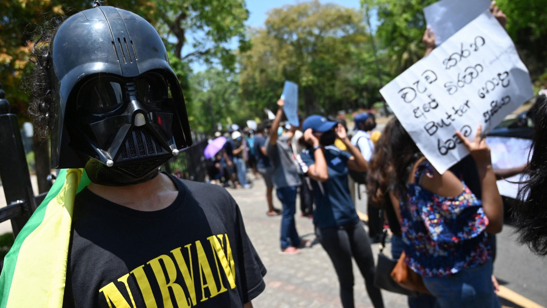 Protestors hold banners during a demonstration against the  surge in prices and shortage of fuel and other essential commodities in  Colombo, Sri Lanka on April 4, 2022.
