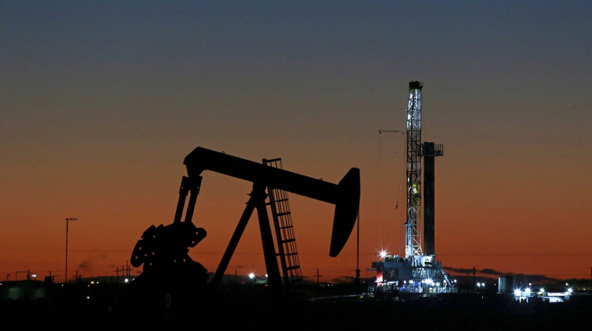 An oil rig and pump jack in Midland, Texas.