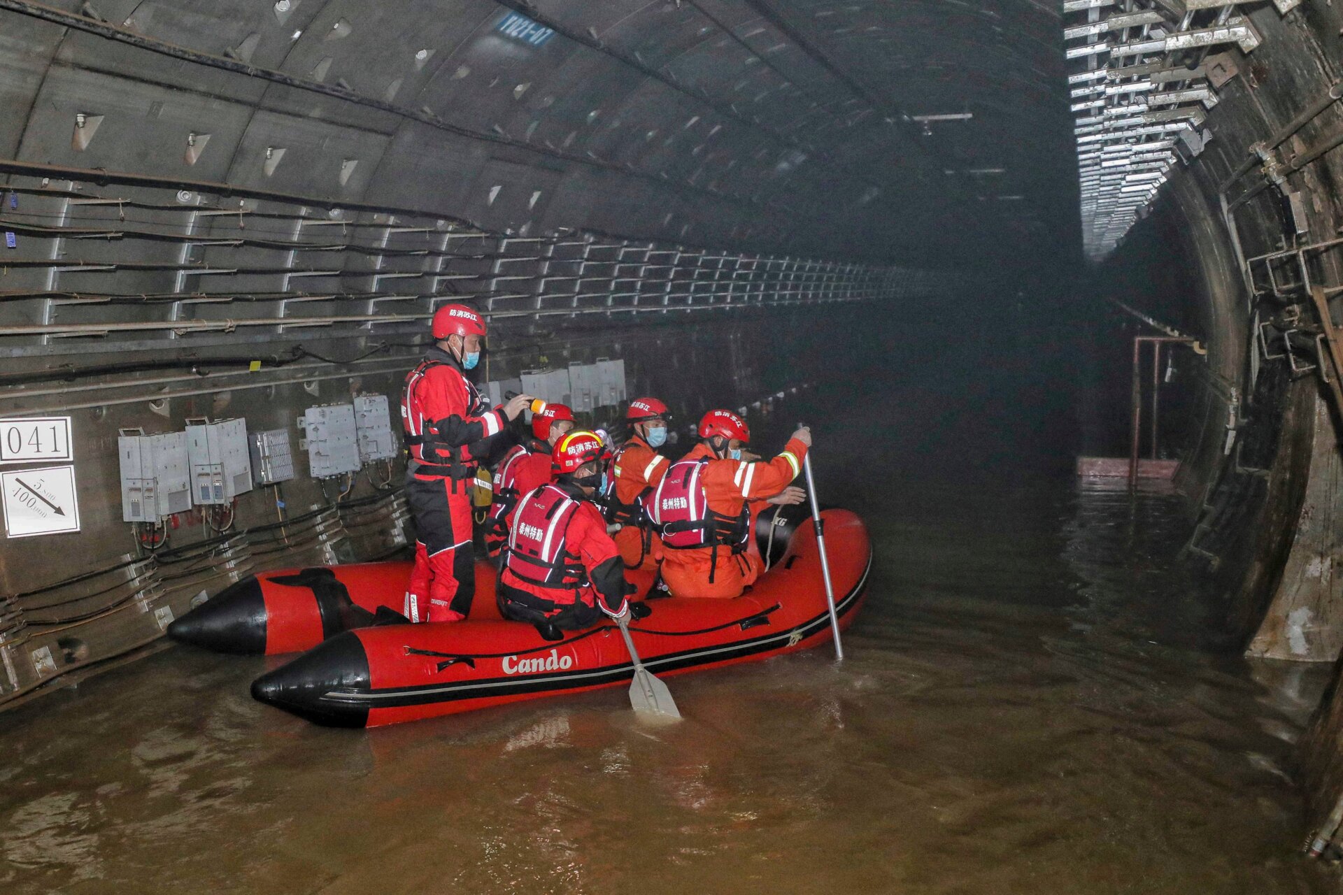 This photo taken on July 26, 2021 shows rescuers searching inside the  subway which was flooded following heavy rains in Zhengzhou, in China’s  central Henan province. 