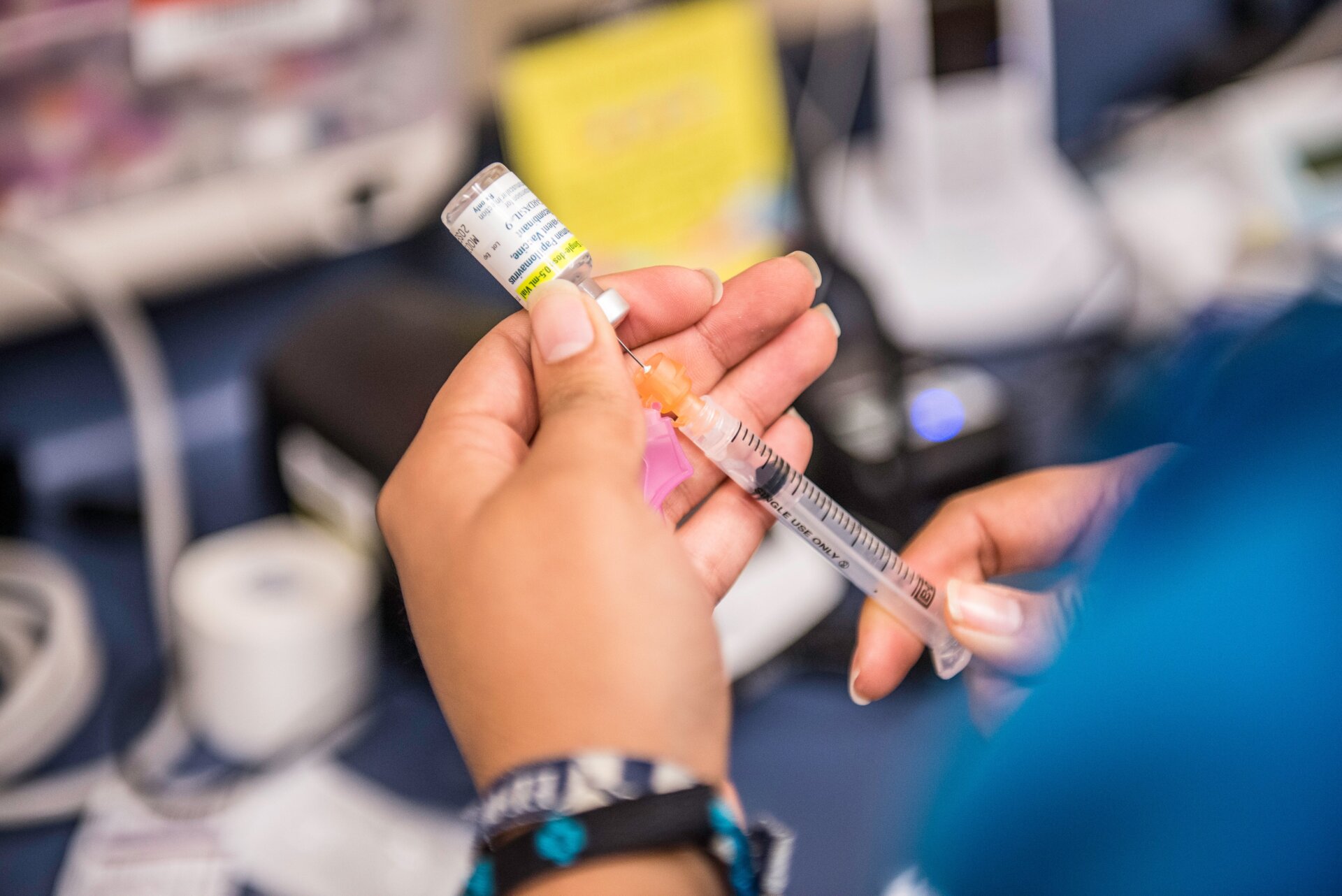 A health care worker preparing a shot of the HPV vaccine.