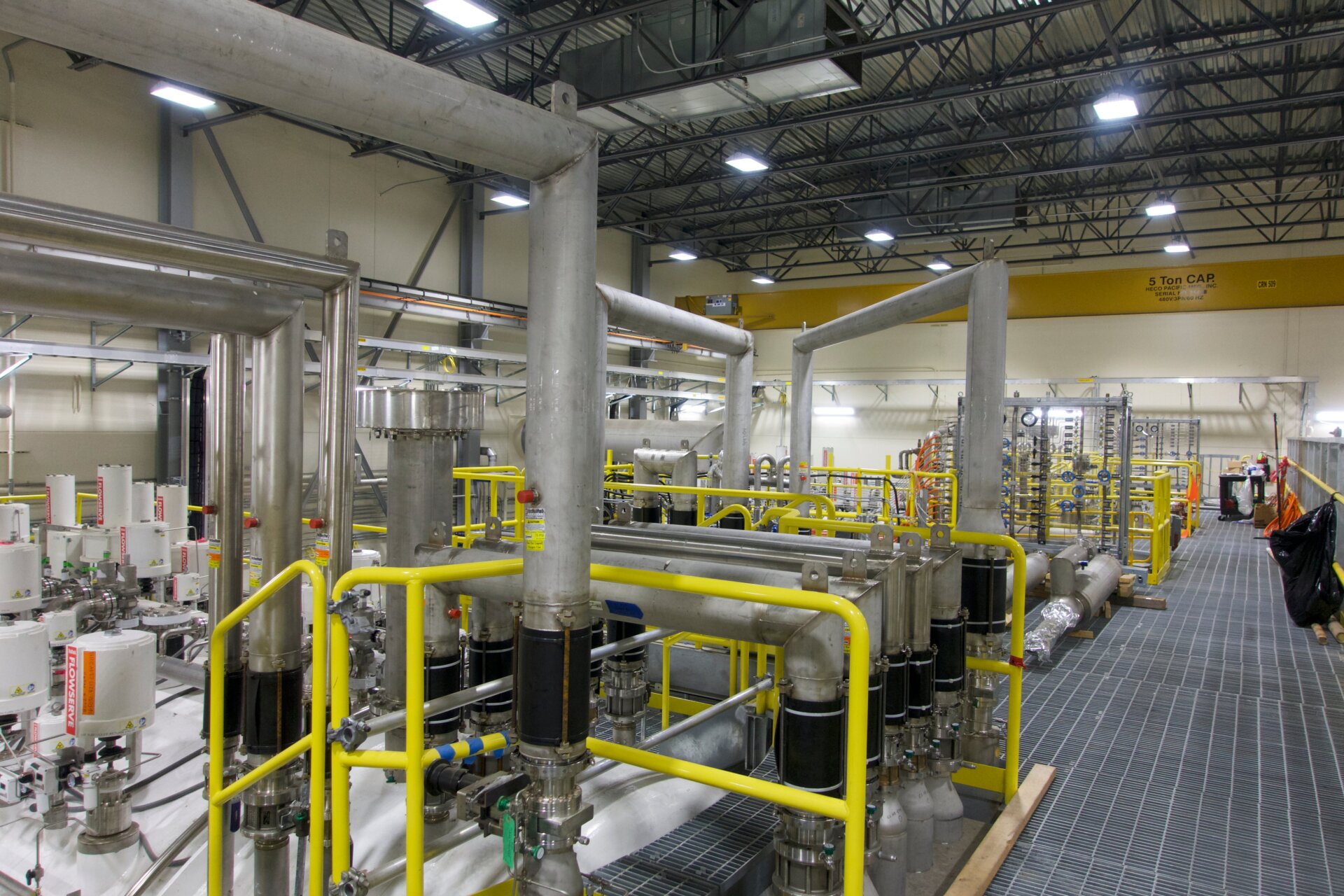 A catwalk connects various vats of cooled helium.