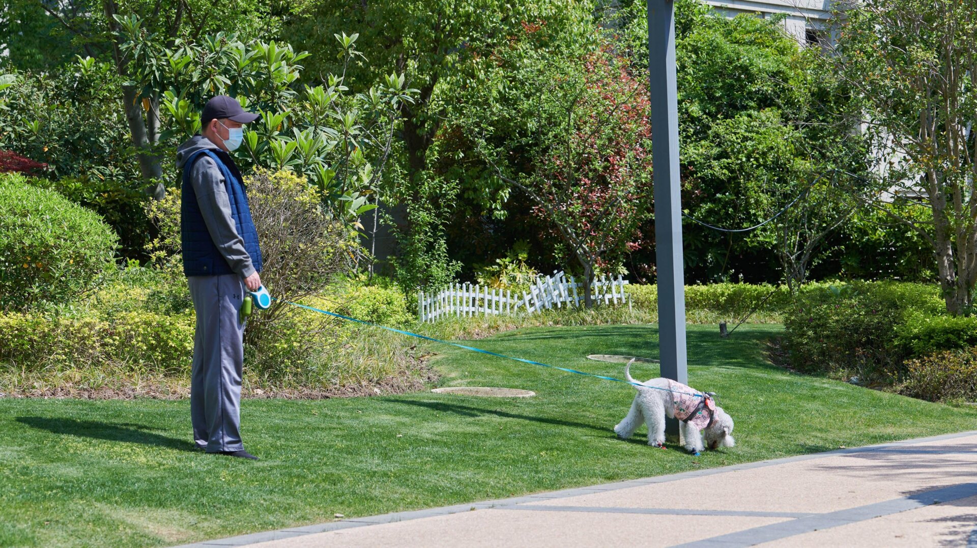 A Shanghai resident walks his dog in a residential housing compound during covid-19 lockdown on April 16, 2022.