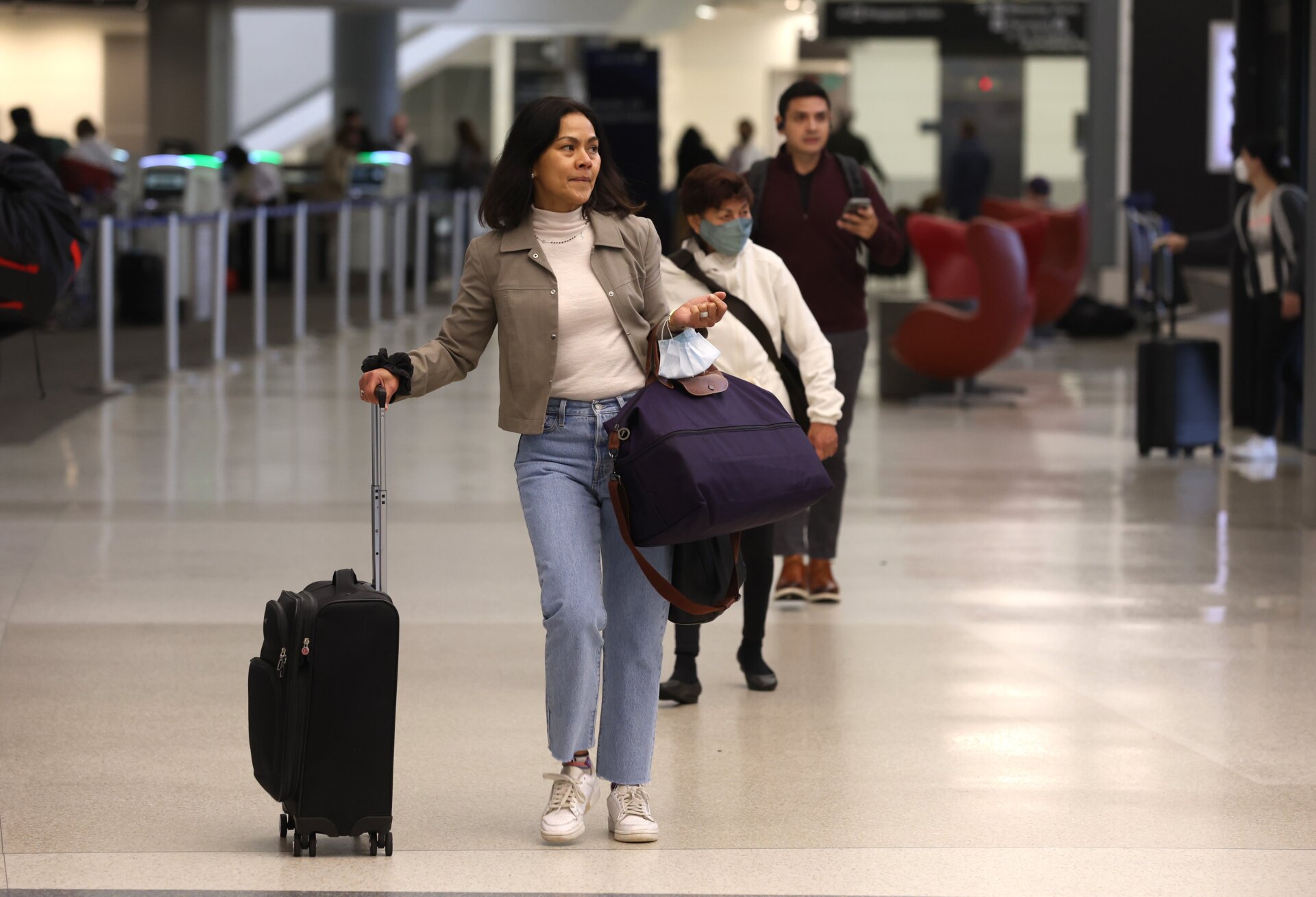 Passengers stroll through San Francisco International Airport April 19, the day after a federal judge shot down the CDC’s mask mandate on public transportation.