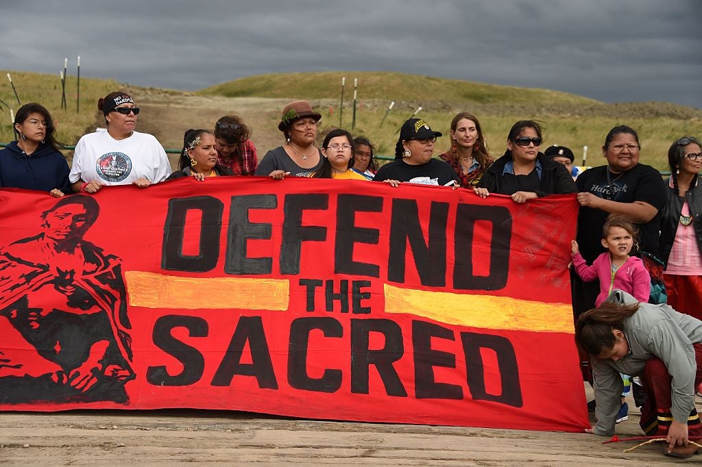Native Americans march to a burial ground sacred site that was disturbed by bulldozers building the Dakota Access Pipeline (DAPL) in 2016 near Cannon Ball, North Dakota. 
