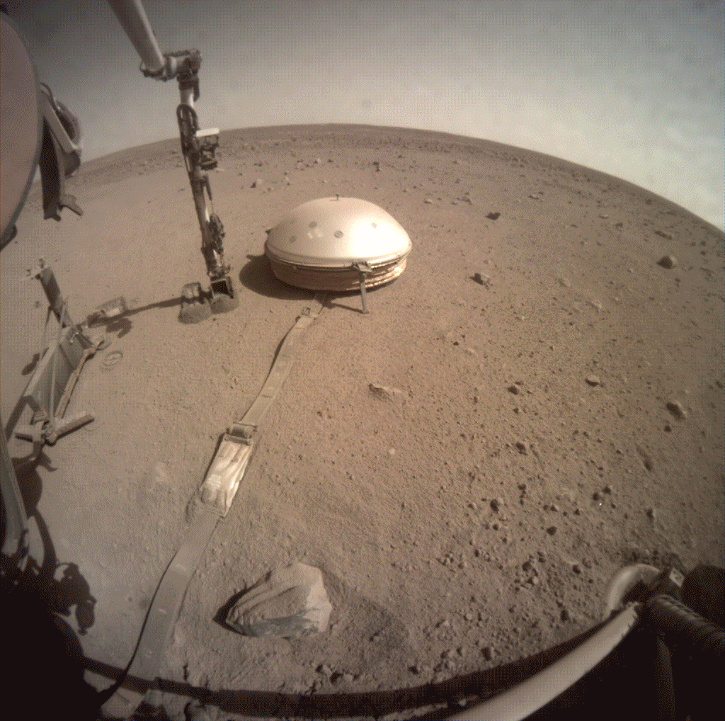 In this gif made of several images taken on March 14, 2021, InSight is seen scooping up Martian dirt and putting it on a cable connecting the seismometer to the lander. NASA scientists hoped that this would help insulate the seismometer’s data from wind and extreme temperature shifts.