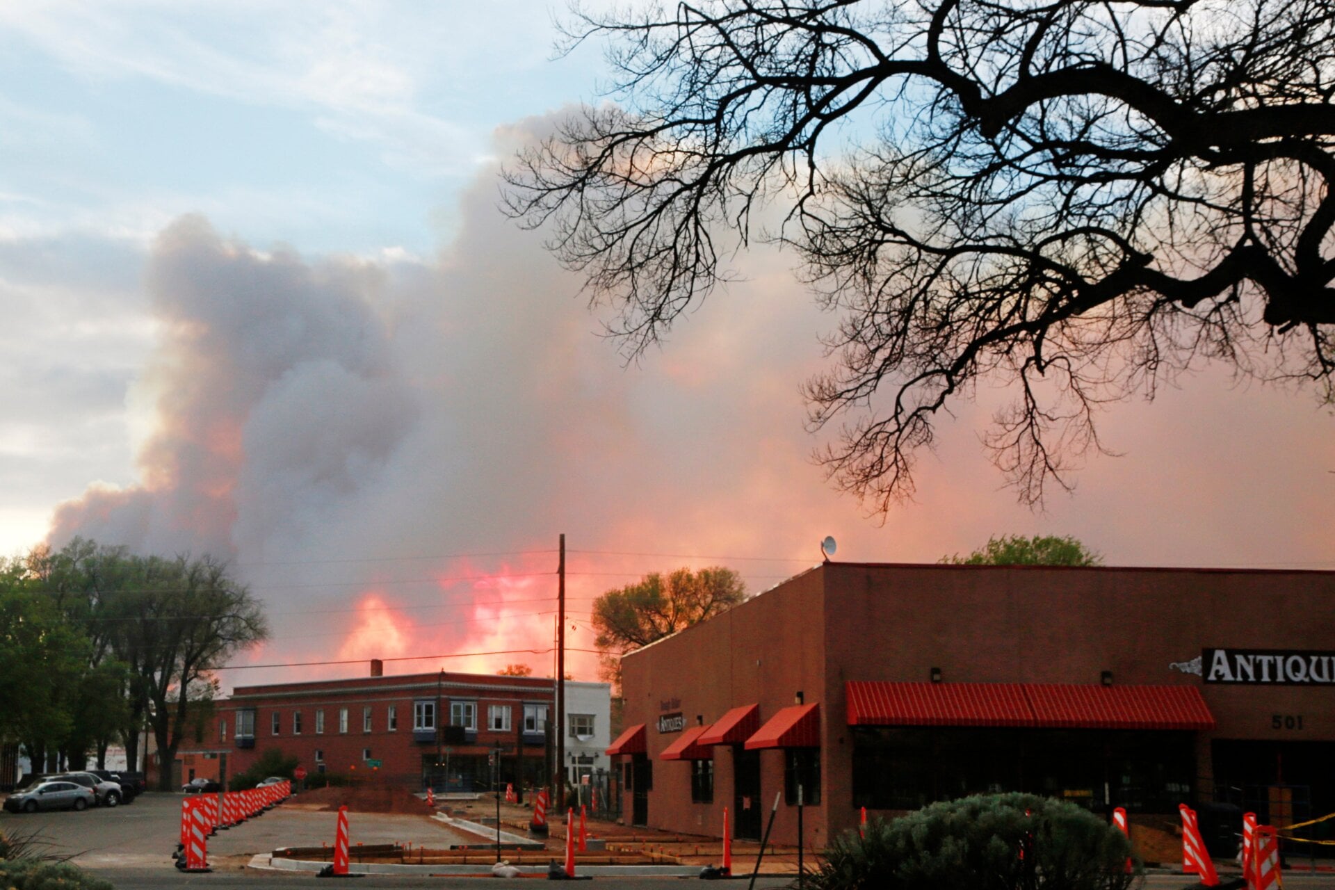 This photo, taken on May 7, shows plumes of wildfire smoke illuminated by a sunset in Las Vegas, New Mexico, where many residents are under evacuation orders.