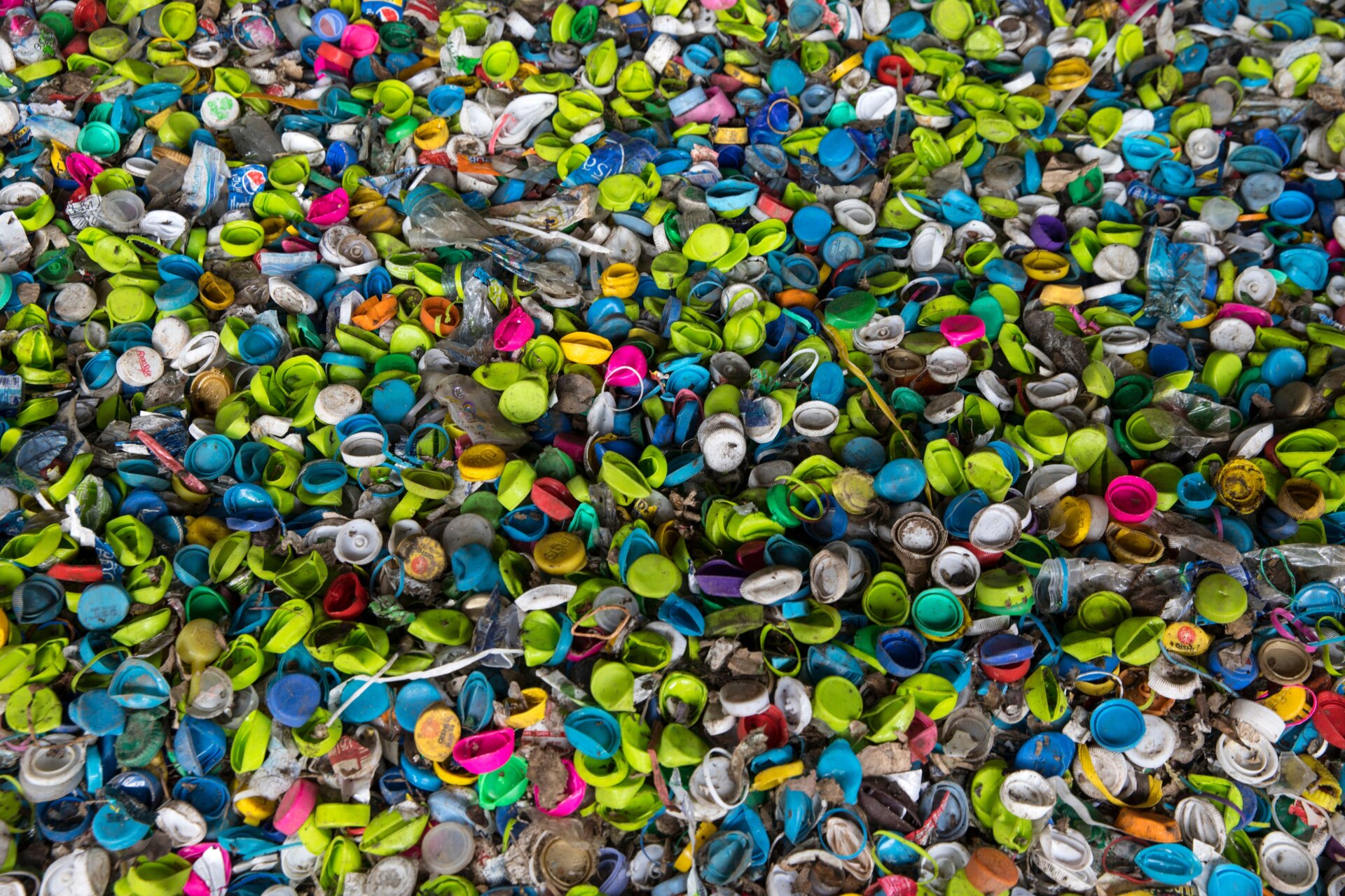 Plastic bottle caps made from HDPE in a recycling processing facility in Nakon Pathom, Thailand.