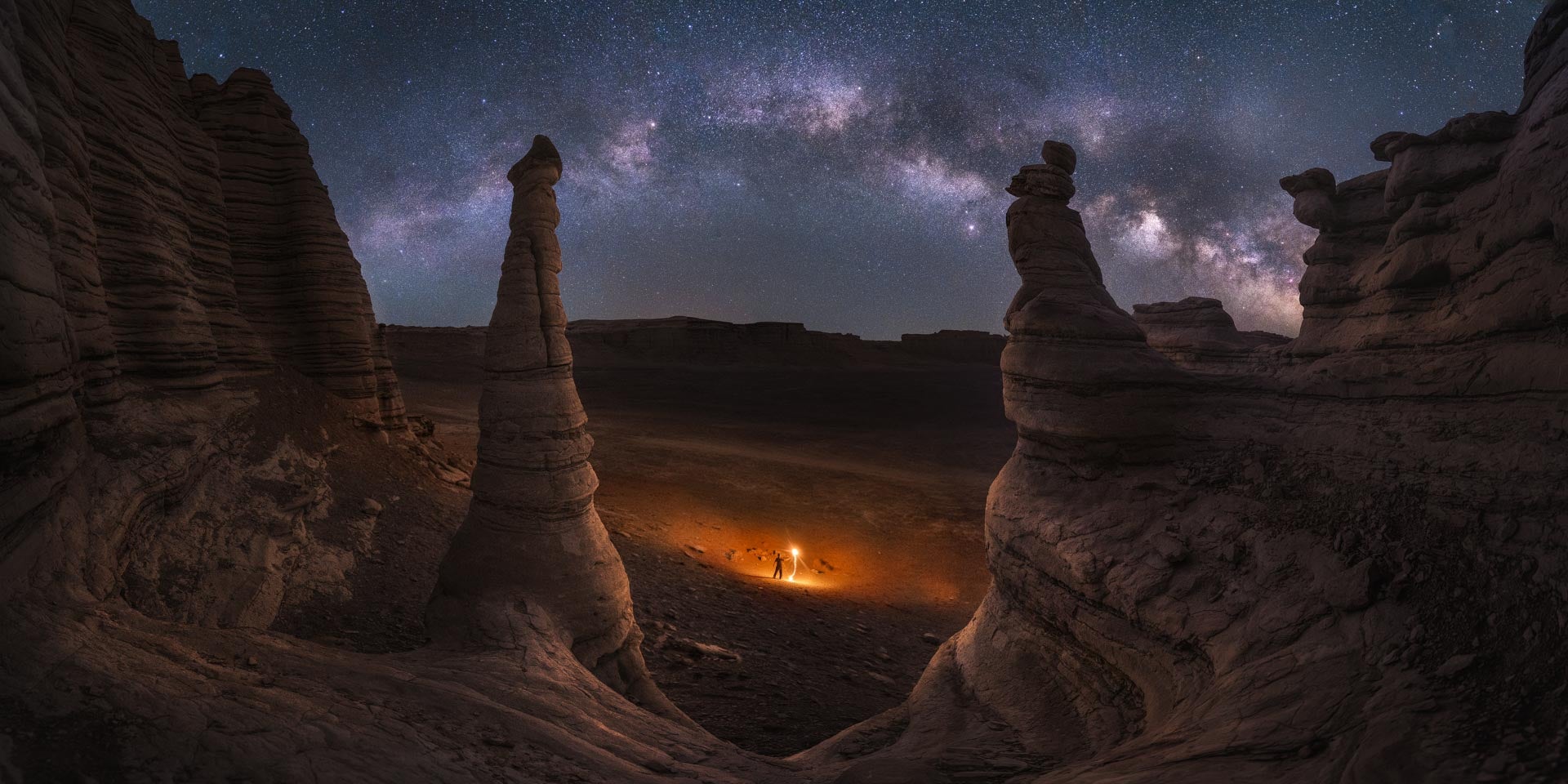 The galaxy above an eroded outcrop of the Dahaidao Desert, China.