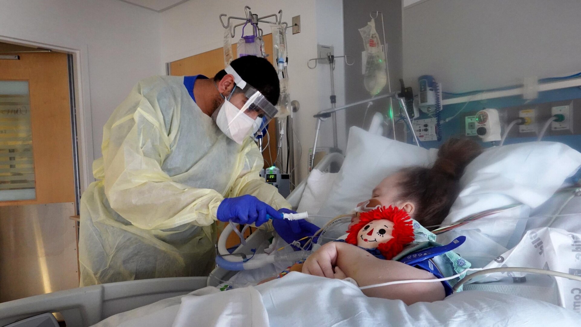Respiratory therapist Adel Al Joaid treats a covid-19 patient in the ICU at Rush University Medial Center in Chicago, Illinois.